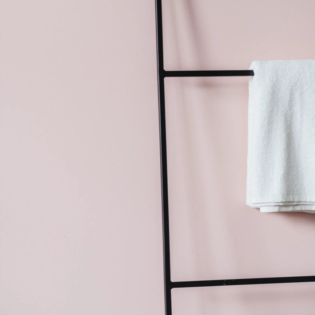 noo.ma Tows Ladder, a modern minimalist freestanding towel ladder crafted from sleek matte black metal, featuring multiple rungs for organized towel storage. Its clean, industrial chic design makes it a versatile bathroom accessory, ideal for Scandinavian-inspired bathrooms, bedrooms, or laundry rooms.