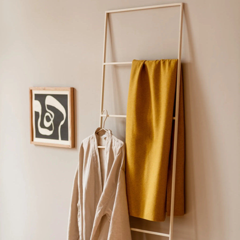 noo.ma Tows Ladder, a modern minimalist leaning ladder crafted from light ash wood with a smooth, matte finish and clean Scandinavian lines.
