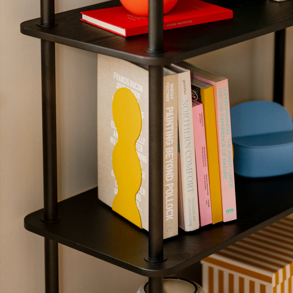 noo.ma Teidi Shelving Unit 5-tier, a modern minimalist 5-tier shelving unit featuring matte black wood shelves with rounded corners and sturdy matte black metal posts. Its sleek, open design with a subtle wood grain texture offers a contemporary and industrial chic aesthetic. Perfect as a display shelf or a functional bookshelf for living rooms, home offices, or Scandinavian-inspired interiors.