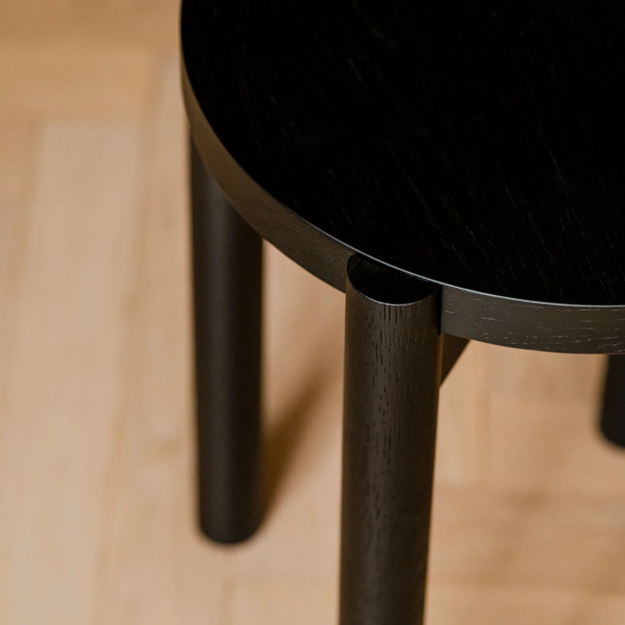 Modern wooden Hopp Stool with round seat and sleek design