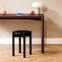 Minimalist modern Hopp stool in light wood finish, with round seat and three straight legs