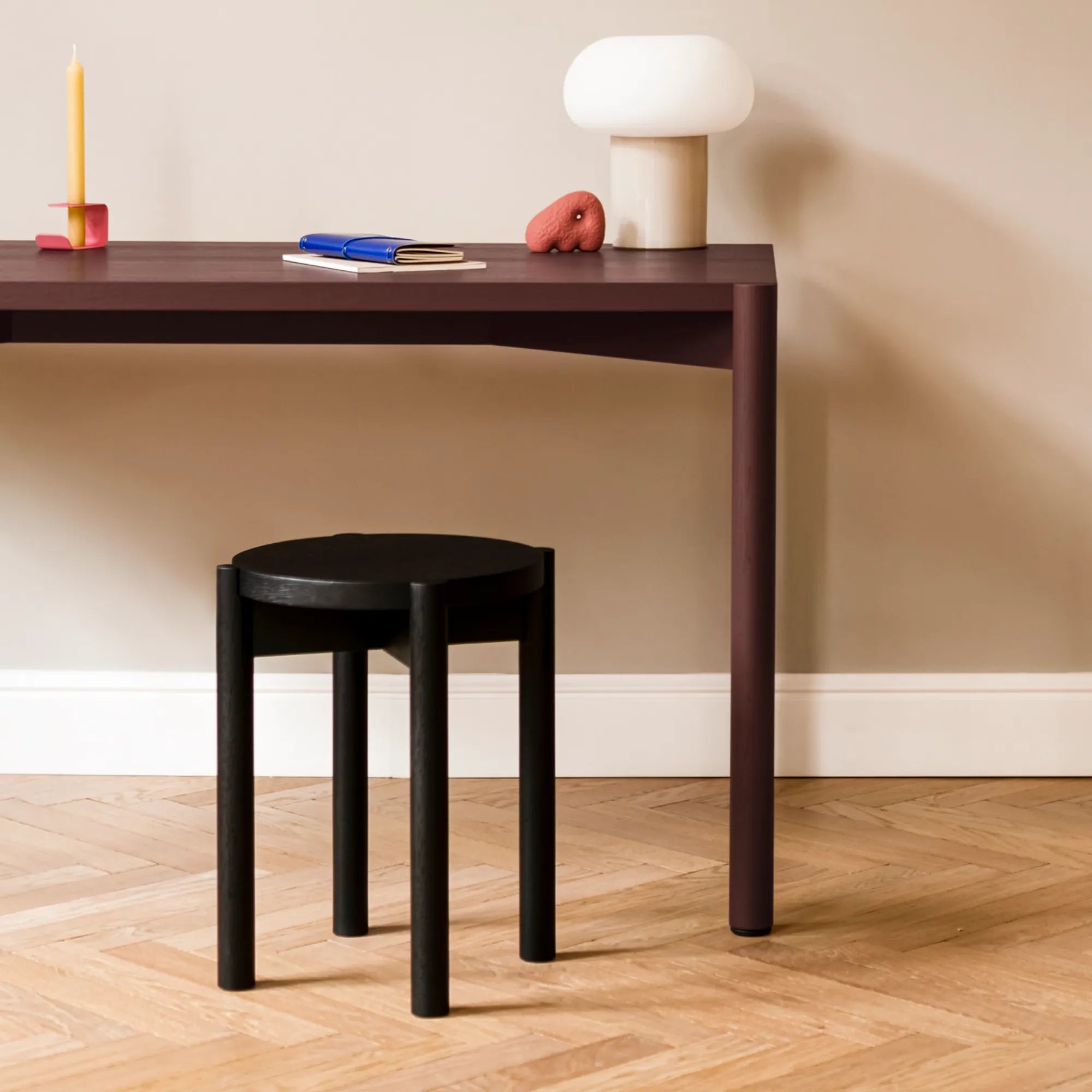 Minimalist modern Hopp stool in light wood finish, with round seat and three straight legs
