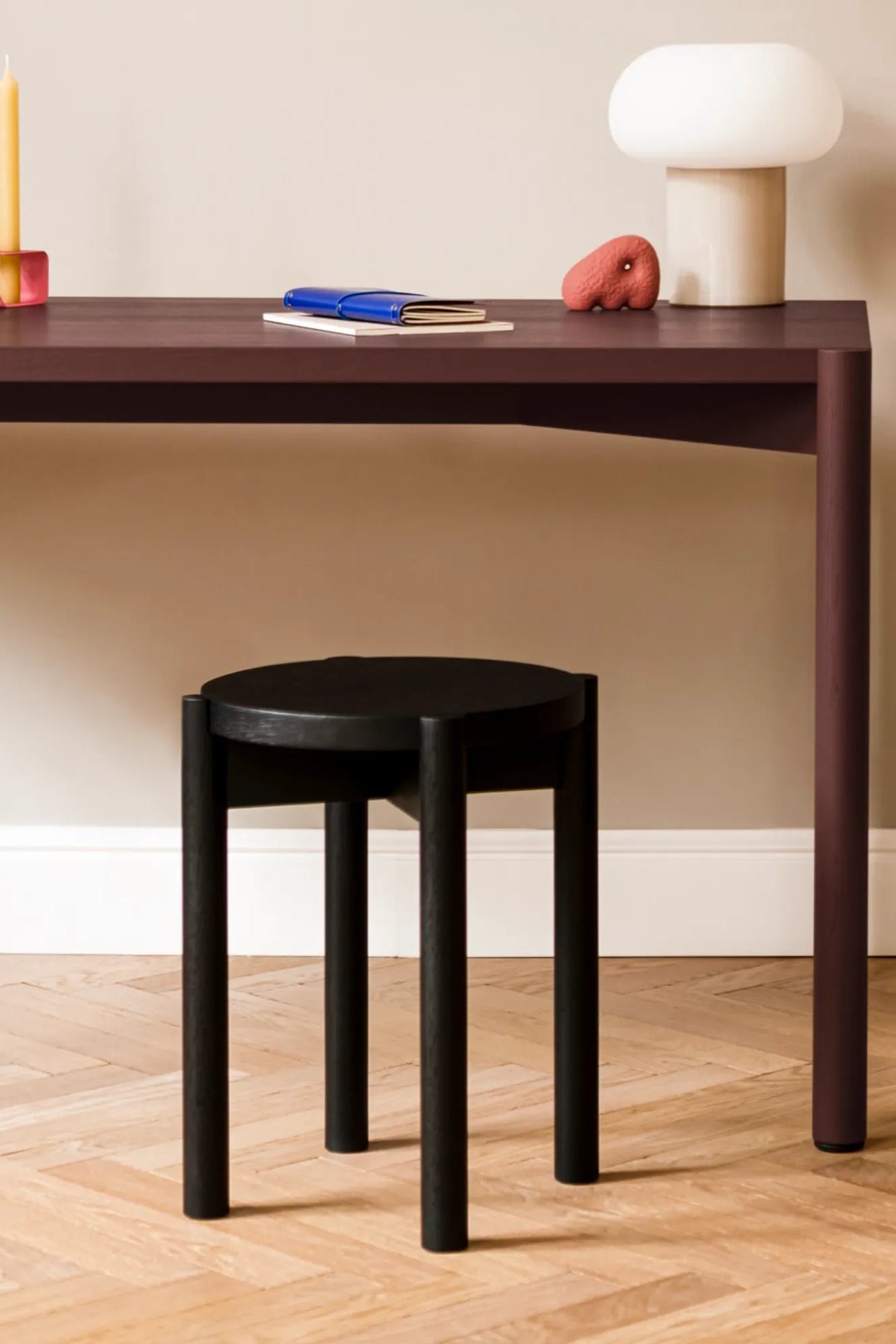 Minimalist modern Hopp stool in light wood finish, with round seat and three straight legs