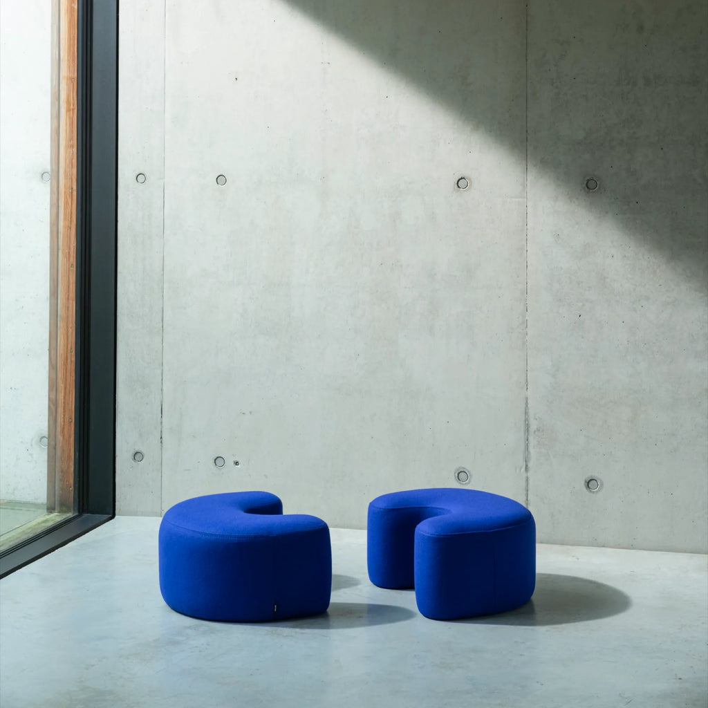 Modern yellow knit Ü Pouf ottoman with wooden legs and cozy texture