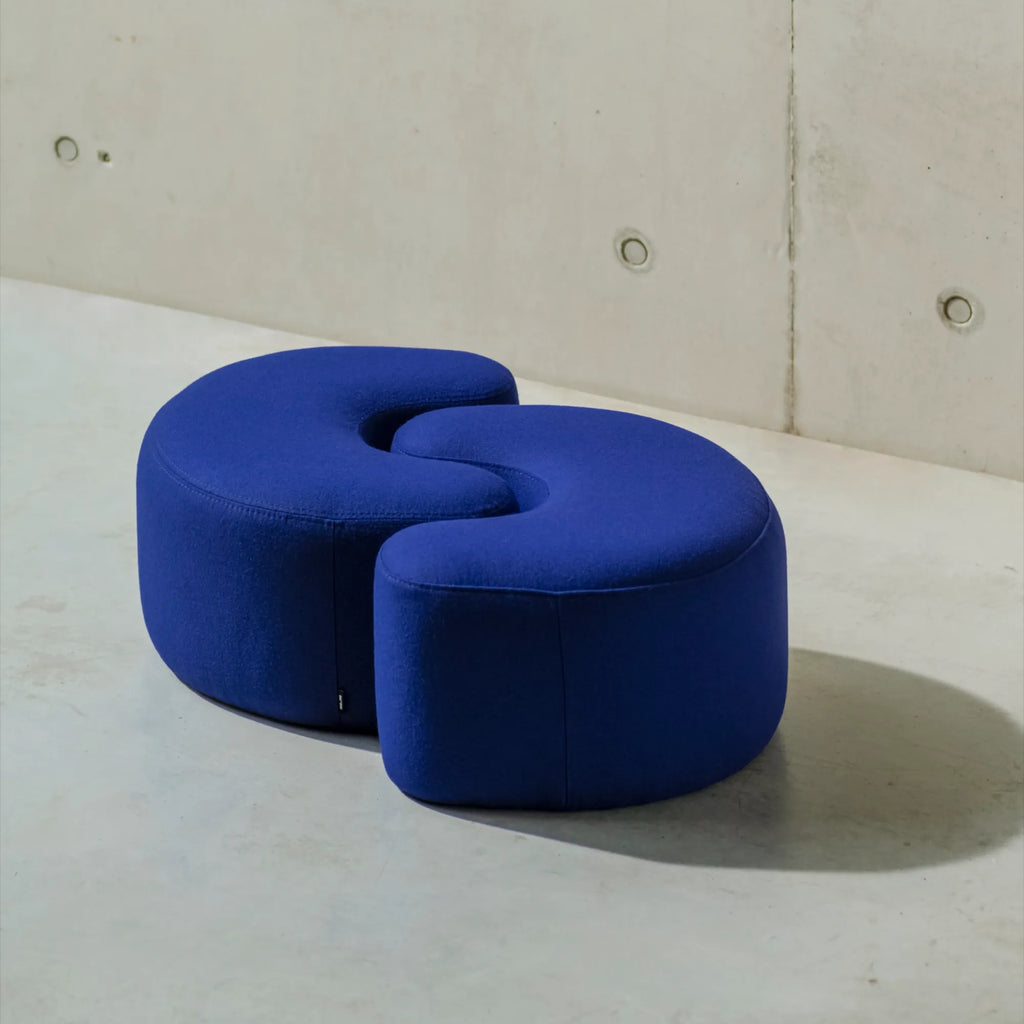 Outdoor patio with Ü Pouf in olive green, offering a casual seating option