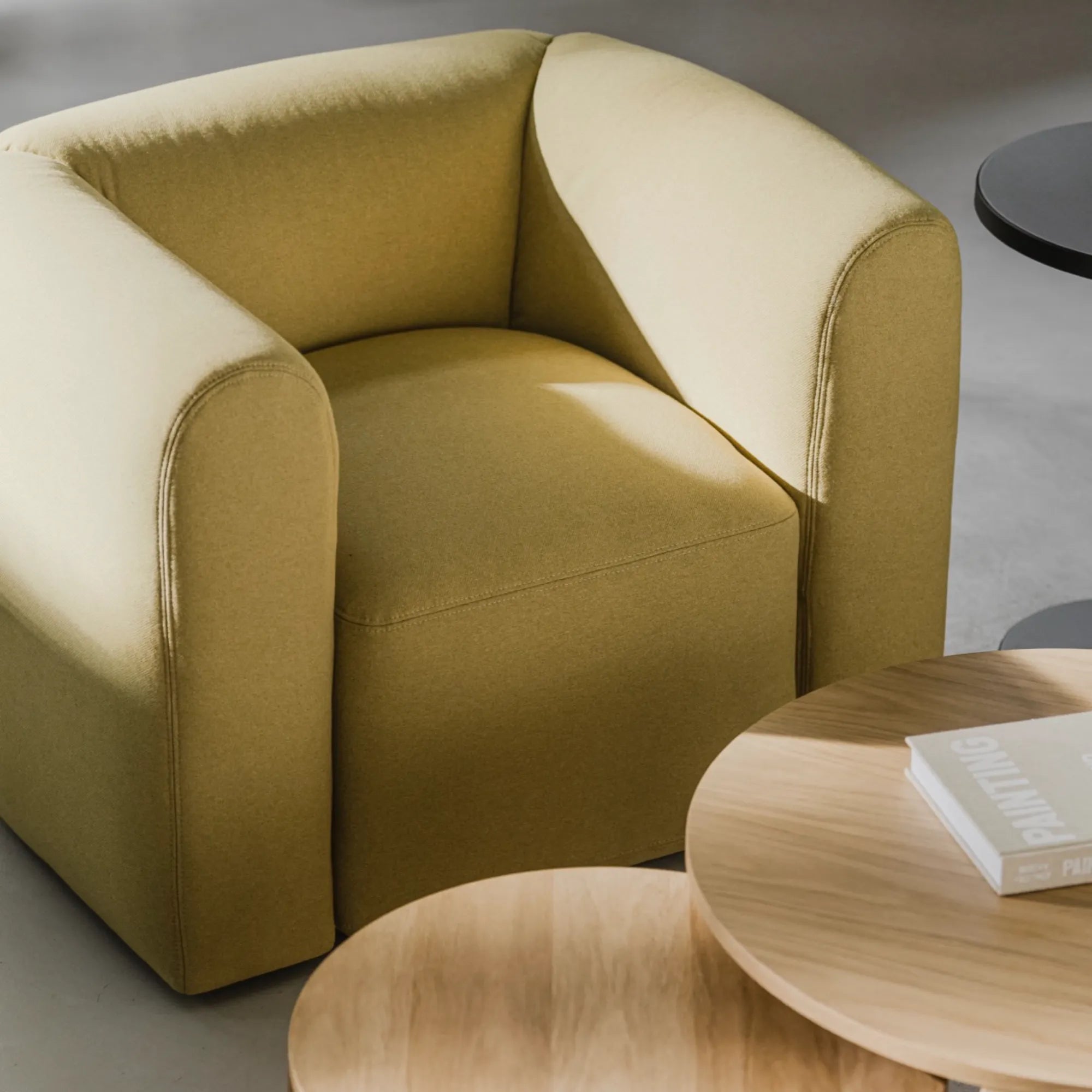 Contemporary Flom Armchair with plush cushioning and sleek, modern design in neutral tones