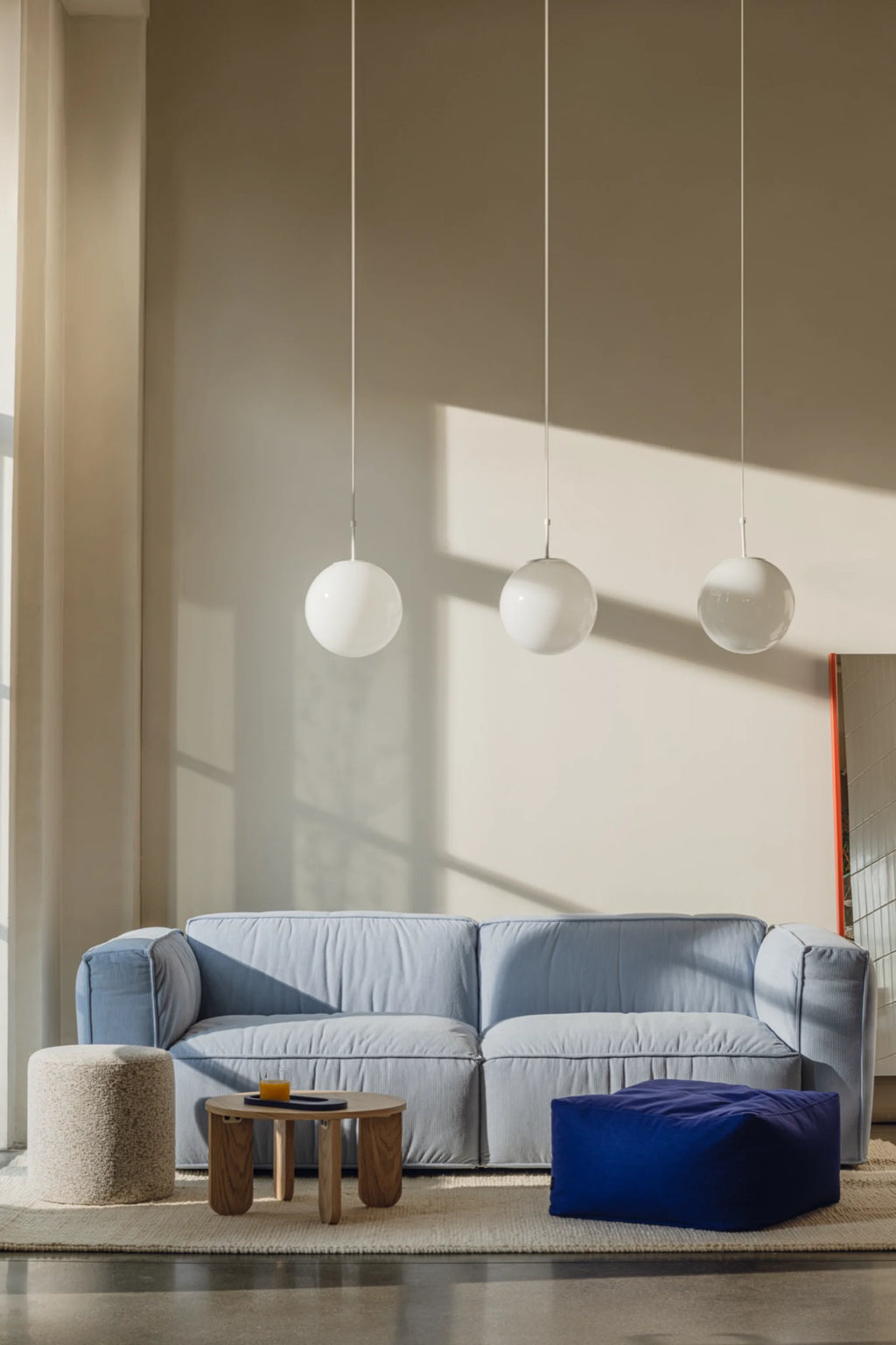 noo.ma Lobi Sofa 3-seater, a contemporary light blue 3-seater sofa upholstered in a soft, ribbed fabric with a relaxed, plush appearance and deep seating. This modern minimalist sofa features a low-profile design and wide, comfortable arms. Perfect for Scandinavian living rooms or spacious apartment interiors seeking comfortable, stylish seating.