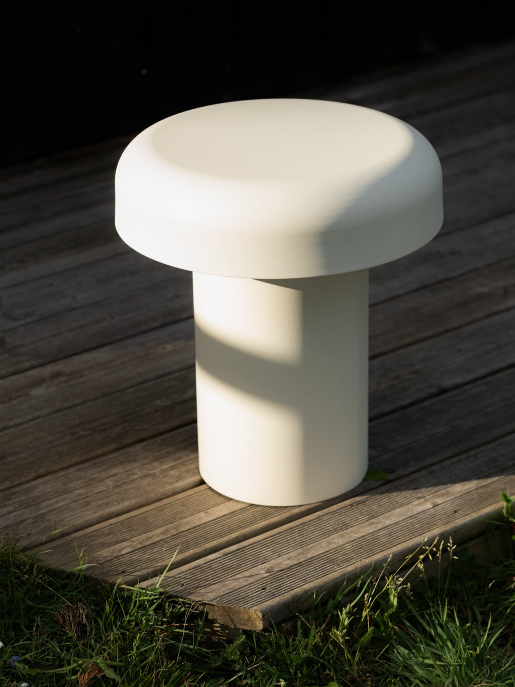 noo.ma Outdoor Miko Side Table, a cream-colored modern minimalist side table with a smooth matte finish and sculptural mushroom-like silhouette, featuring a sturdy cylindrical base and a wide,.