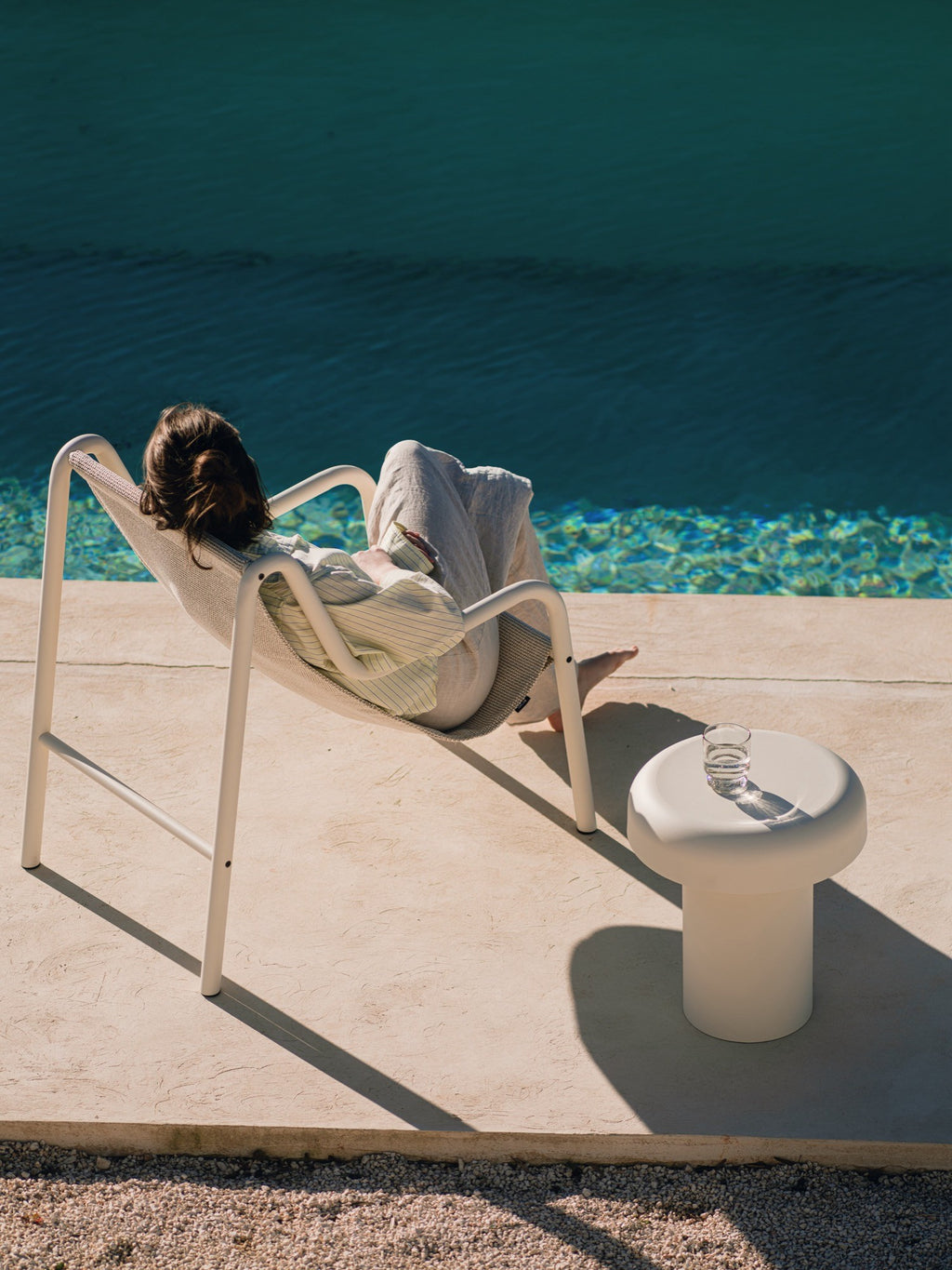 noo.ma Outdoor Miko Side Table, a modern minimalist patio side table in a soft off-white hue with a smooth, matte finish and a distinctive sculptural, organic mushroom shape. Crafted from durable, weather-resistant material, it’s perfect as a contemporary outdoor accent table for poolside lounging, garden spaces, or balcony decor.