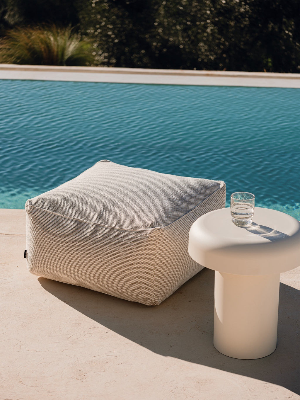 noo.ma Outdoor Miko Side Table, a modern minimalist outdoor accent table crafted with a smooth, matte off-white finish and a distinctive mushroom-shaped silhouette.