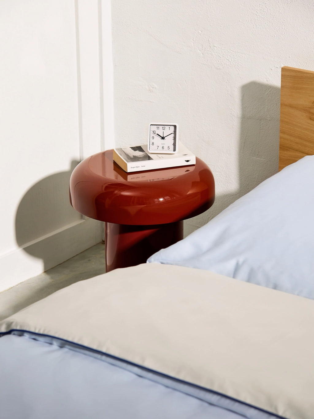 noo.ma Miko Side Table, a striking glossy red sculptural side table featuring a high-gloss lacquered finish and a distinctive mushroom-like silhouette with a rounded top and sturdy cylindrical base. This modern minimalist accent table is perfect for contemporary bedrooms as a chic bedside table or as a bold statement piece in a modern living room.