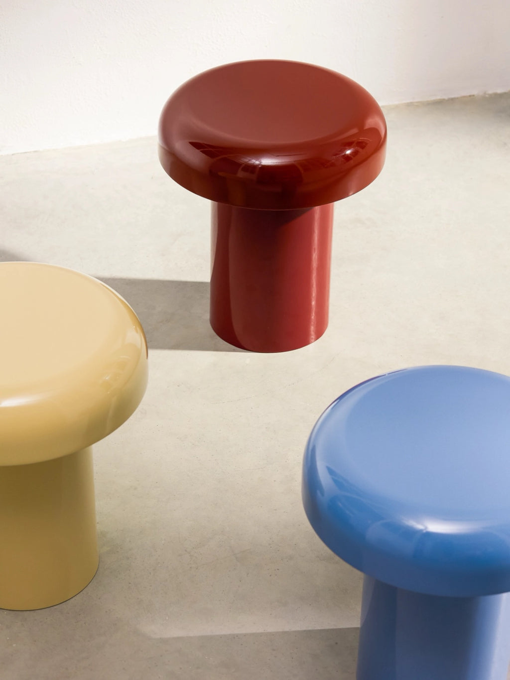 noo.ma Miko Side Table, a collection of contemporary sculptural side tables crafted from glossy powder-coated steel, featuring a distinctive mushroom-shaped design with a rounded top and sturdy cylindrical base.