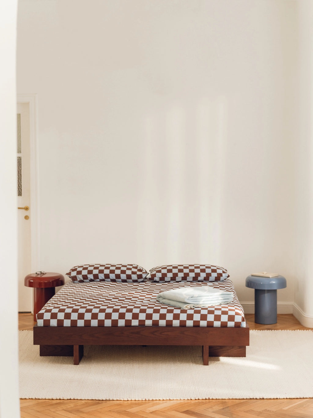 noo.ma Miko Side Table, a contemporary sculptural accent table crafted from lacquered wood with a smooth, glossy reddish-brown finish, featuring a distinctive cylindrical base and mushroom-like.
