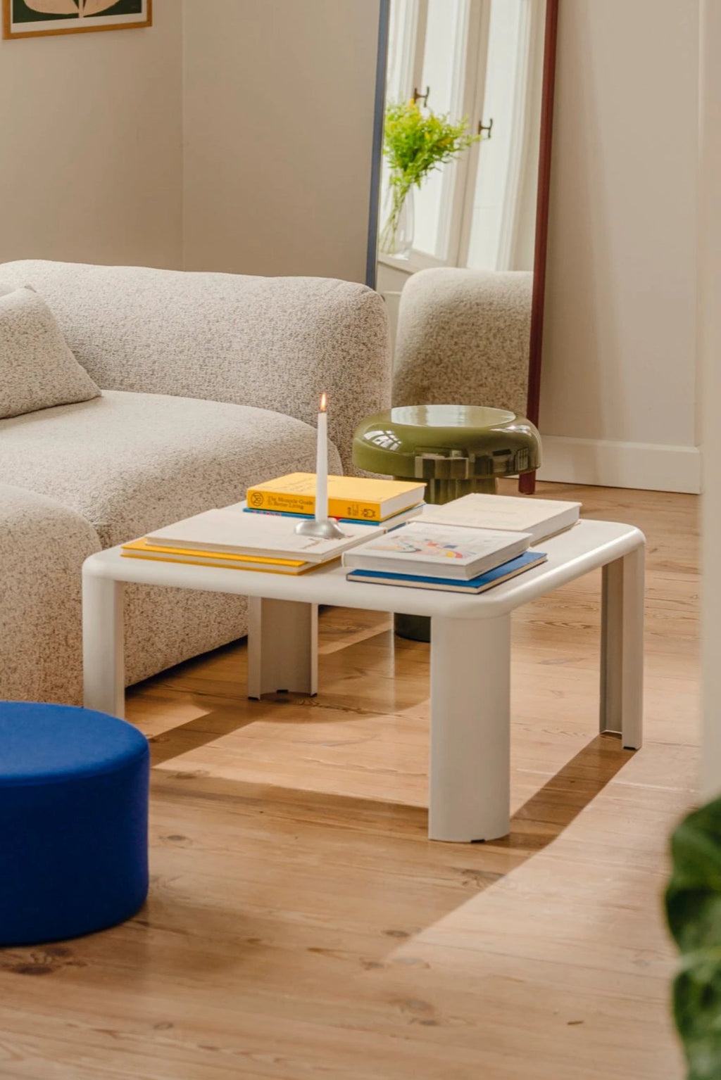 noo.ma Fli Coffee Table, a contemporary light grey powder-coated steel coffee table featuring a smooth rectangular top with gently rounded corners and four thick, sculptural rounded legs. This modern minimalist piece offers a soft, matte finish and a chunky, playful aesthetic, making it an ideal central piece for modern living rooms or a stylish end table in organic modern interiors.