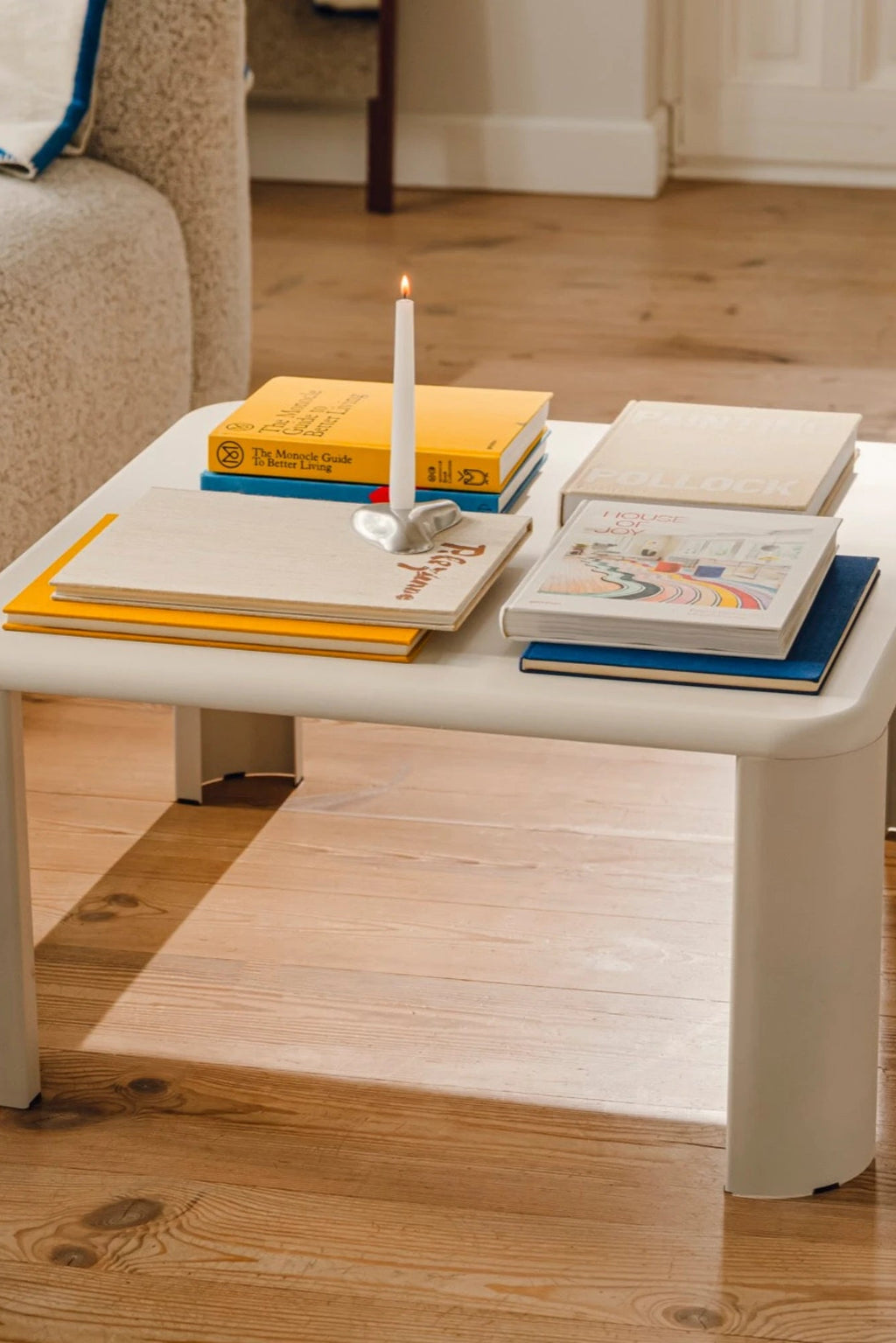 noo.ma Fli Coffee Table, a modern minimalist coffee table crafted from matte white lacquered MDF with a soft rectangular top featuring gently rounded corners and thick, cylindrical legs. This contemporary white coffee table offers a clean, Scandinavian aesthetic for living rooms and modern interiors.