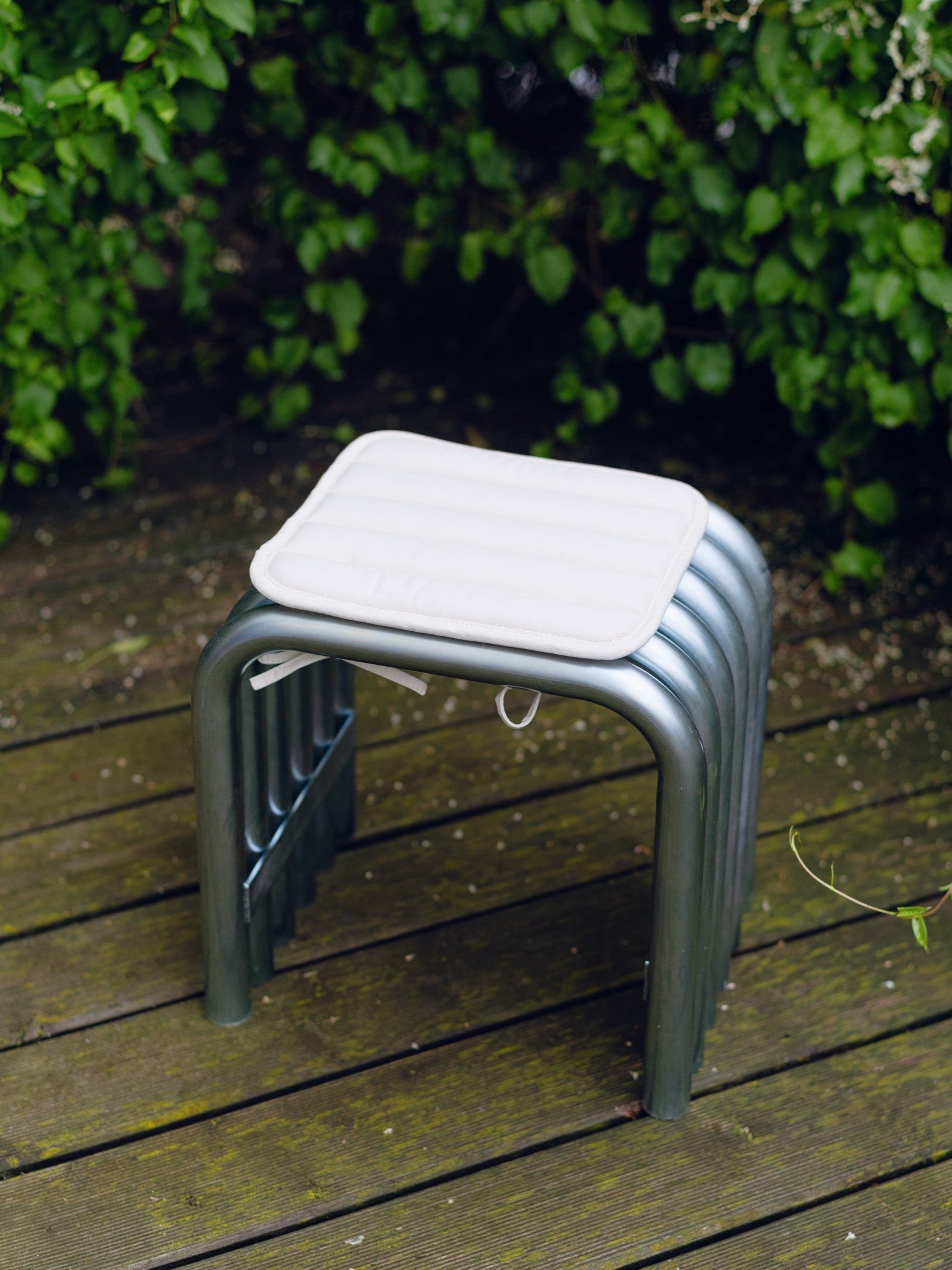 noo.ma Nokk Stool, a modern minimalist accent stool featuring a sleek dark grey powder-coated tubular steel frame with a distinctive bent U-shaped design that forms sturdy legs and a rectangular.