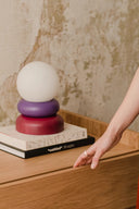 Close-up of Otem Table Lamp showing intricate metal detailing and smooth glass base