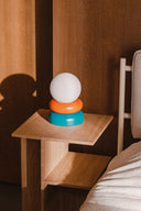 Otem Table Lamp with soft warm light illuminating a cozy reading nook