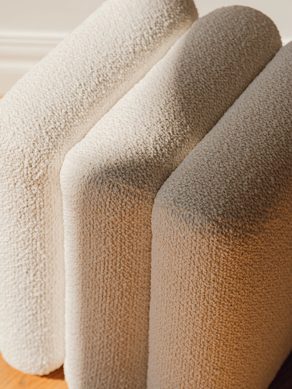 noo.ma Radd Pouf, an off-white bouclé fabric pouf featuring a plush, deeply textured looped surface and soft, rounded, modular form.