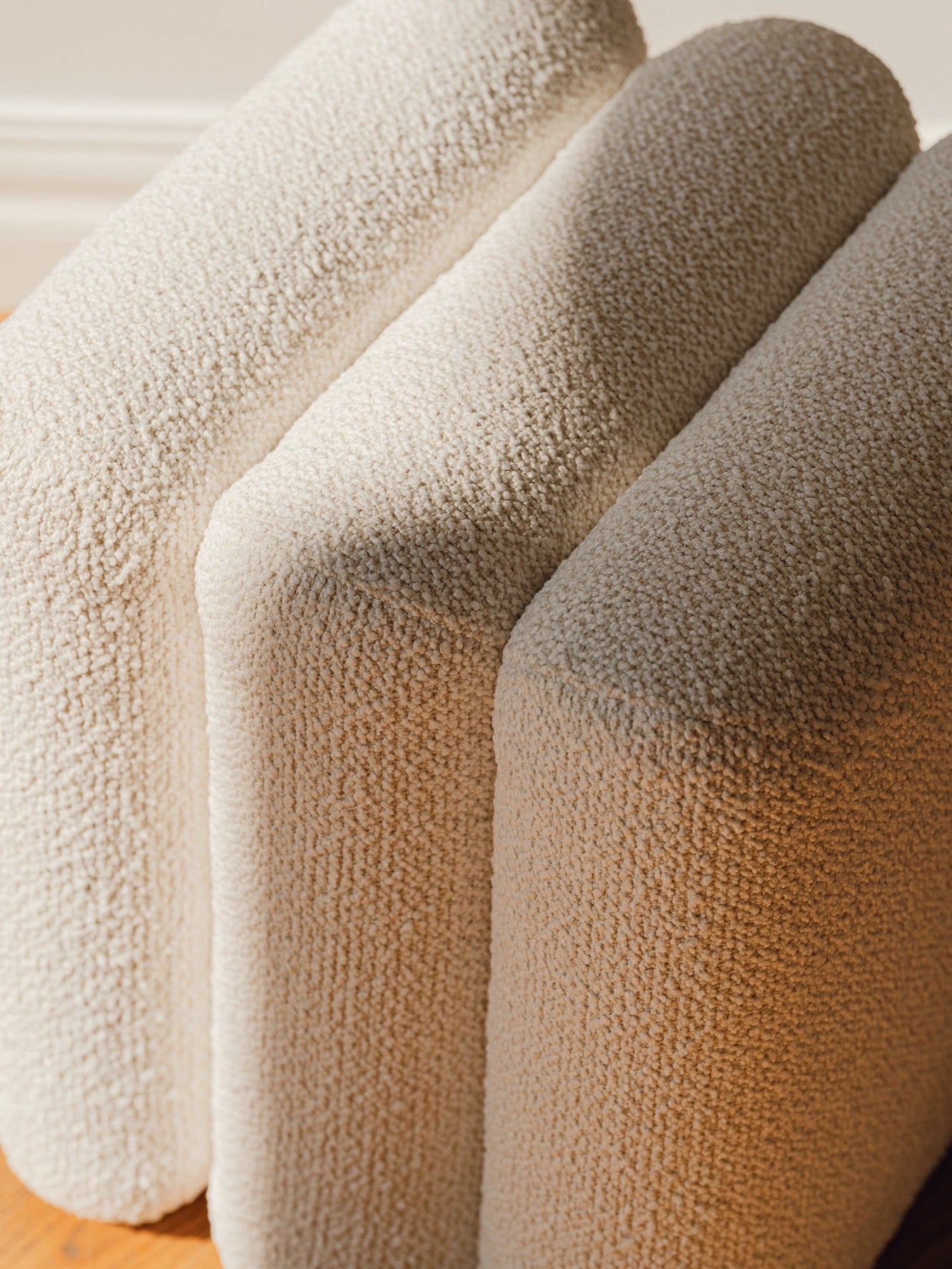 noo.ma Radd Pouf, an off-white bouclé fabric pouf featuring a plush, deeply textured looped surface and soft, rounded, modular form.