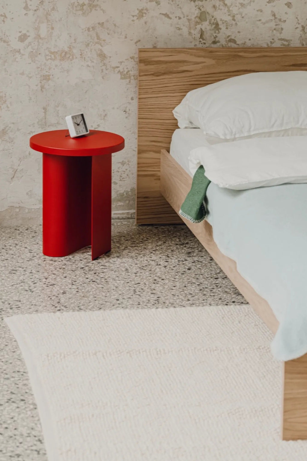 noo.ma Sato Side Table, a vibrant red modern minimalist side table crafted from matte lacquered wood, featuring a round top and a unique sculptural split cylindrical base.