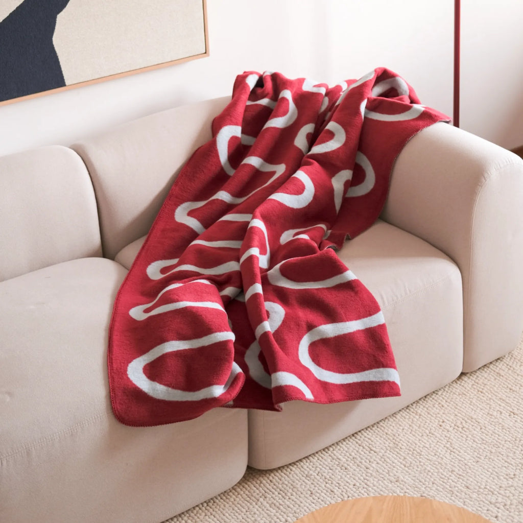 Stylish Swirl Throw Blanket in a modern steel blue with a lustrous finish