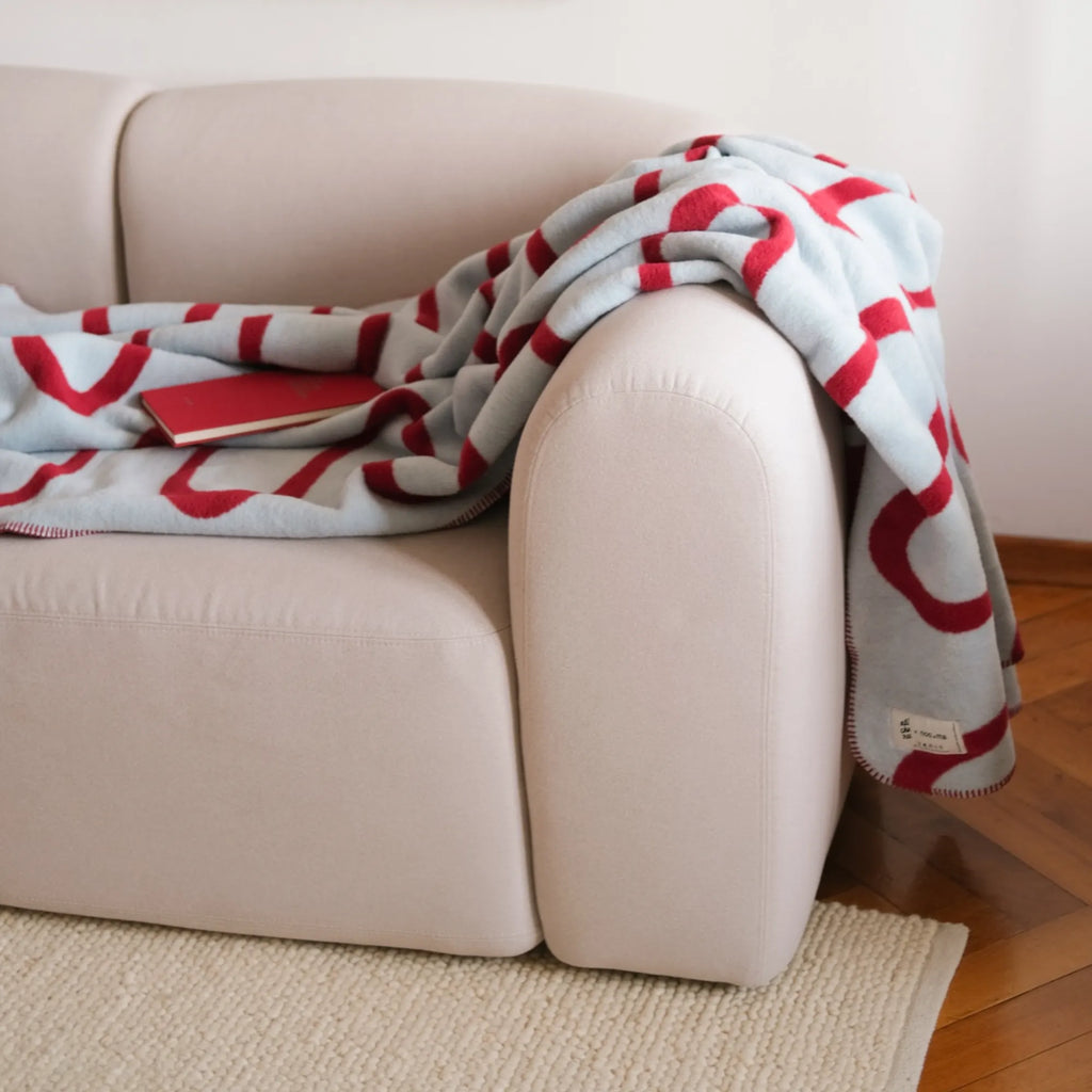 Soft Swirl Throw Blanket in a light ivory color with a plush texture