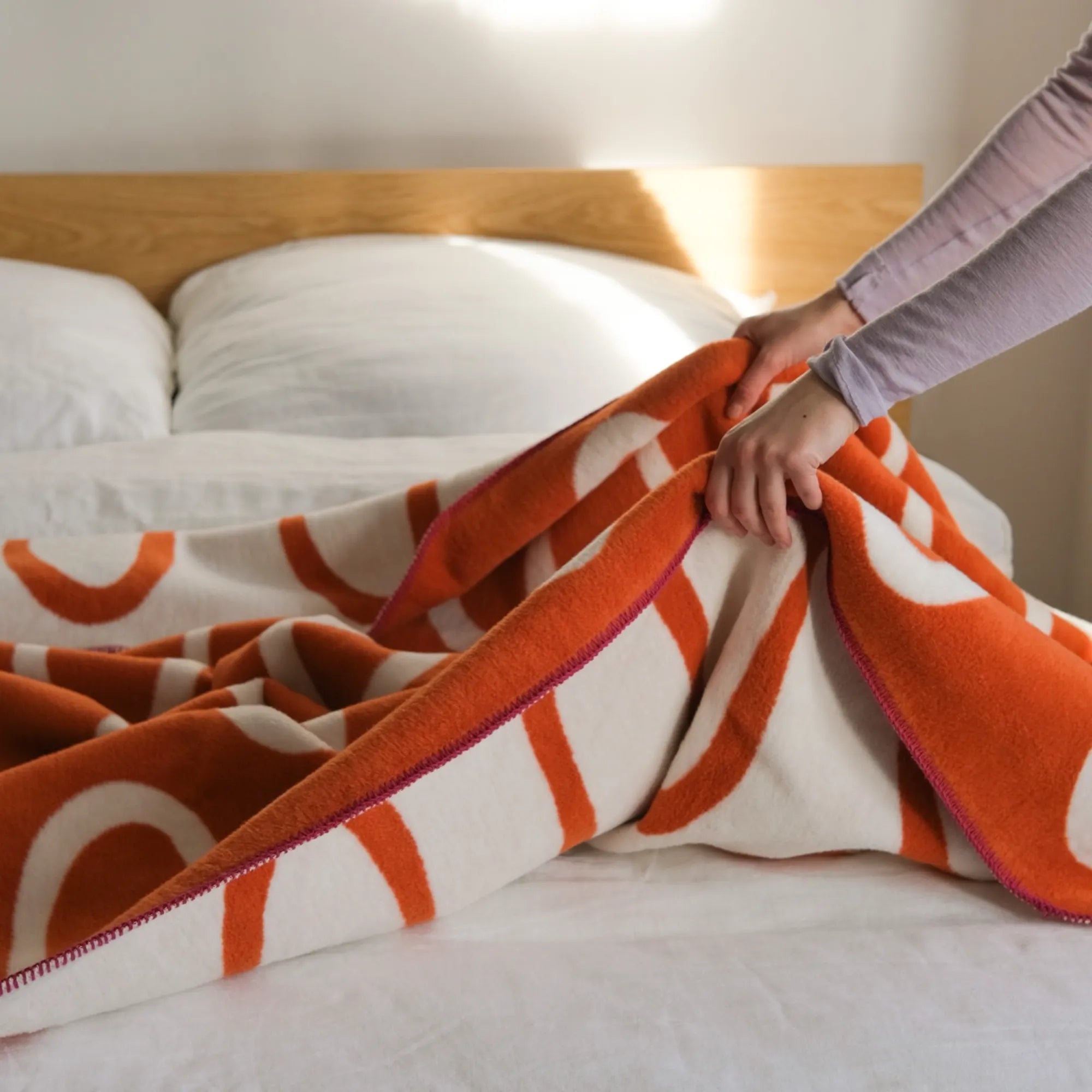 Elegant Swirl Throw Blanket in a dusty rose pink with a subtle shimmer