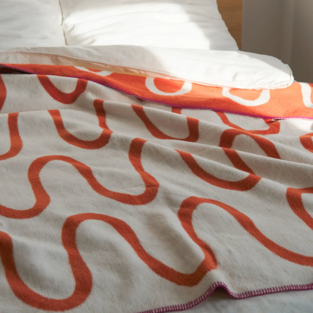 Soft and luxurious Swirl Throw Blanket in a warm camel color