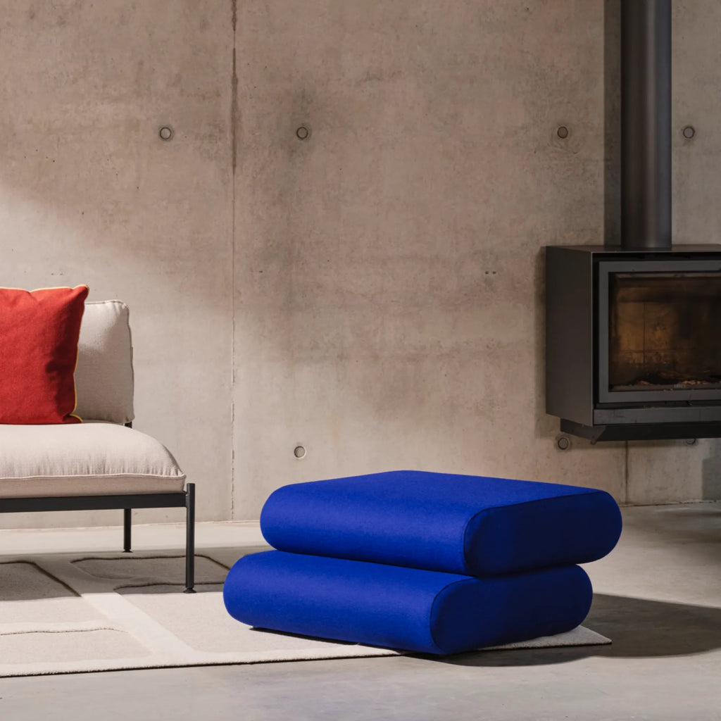 Close-up of Taso Pouf's sturdy wooden frame and plush cushioning