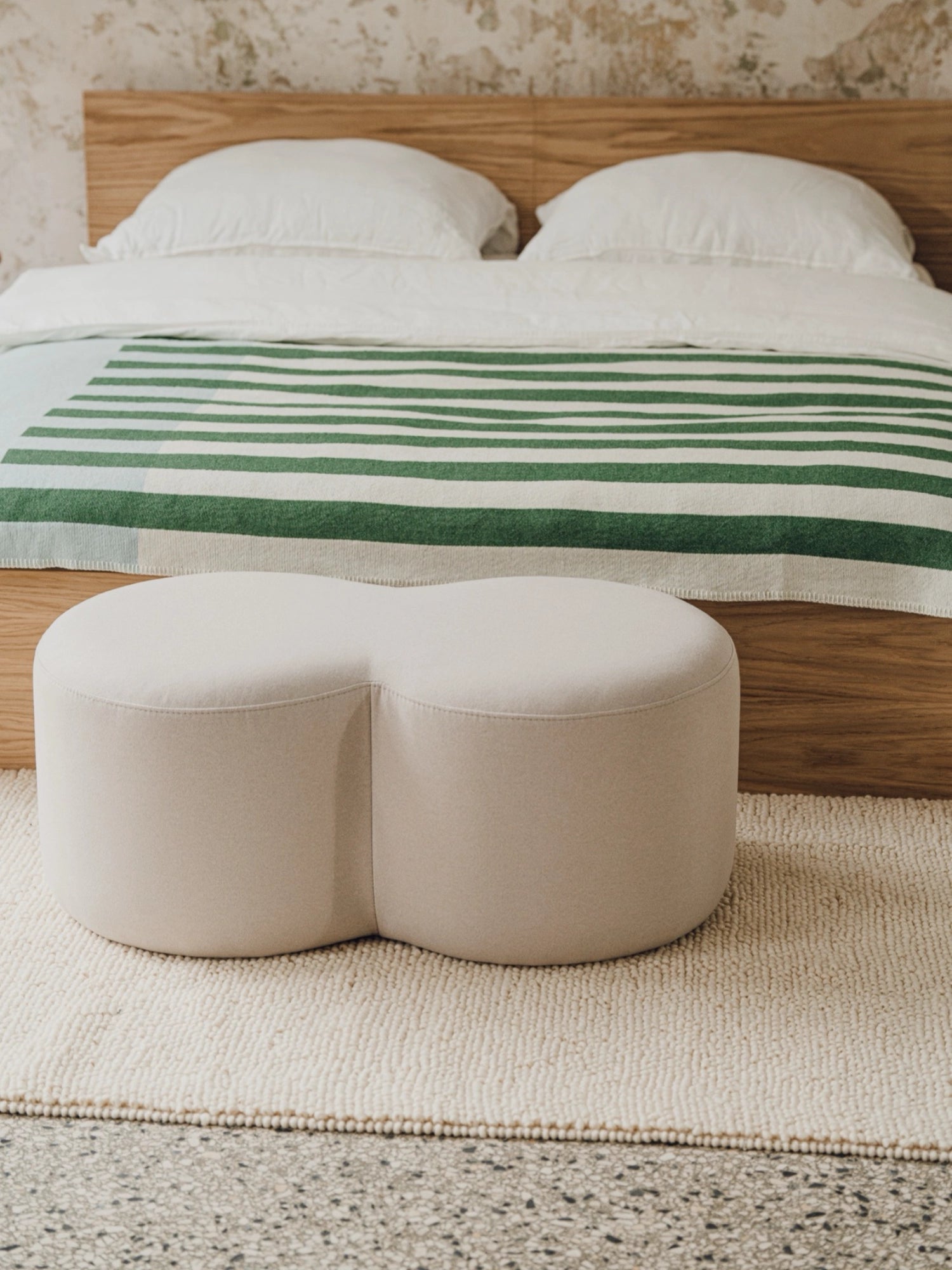 noo.ma Umbo Pouf, a contemporary organic modern pouf upholstered in a soft light beige fabric with a distinctive double-lobed rounded silhouette. Its plush, minimalist design offers versatile accent seating or a comfortable footrest, perfect for Scandinavian bedrooms, cozy living rooms, or chic nursery decor.