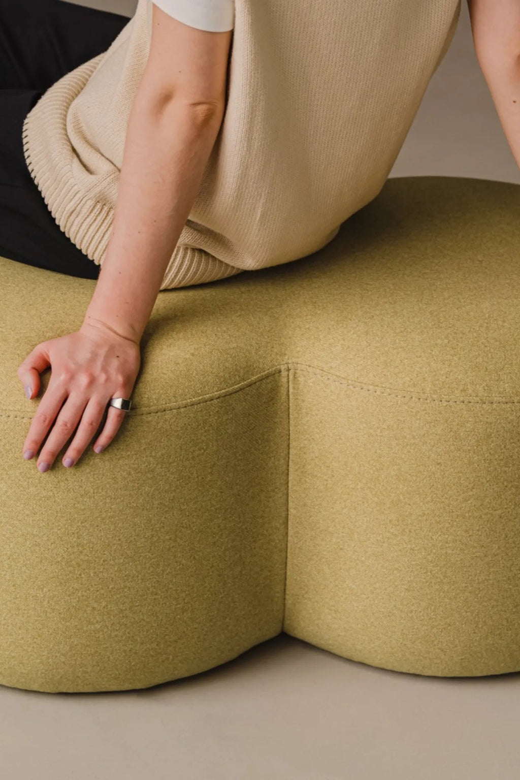 Umbo Pouf with stitching details and plush seat
