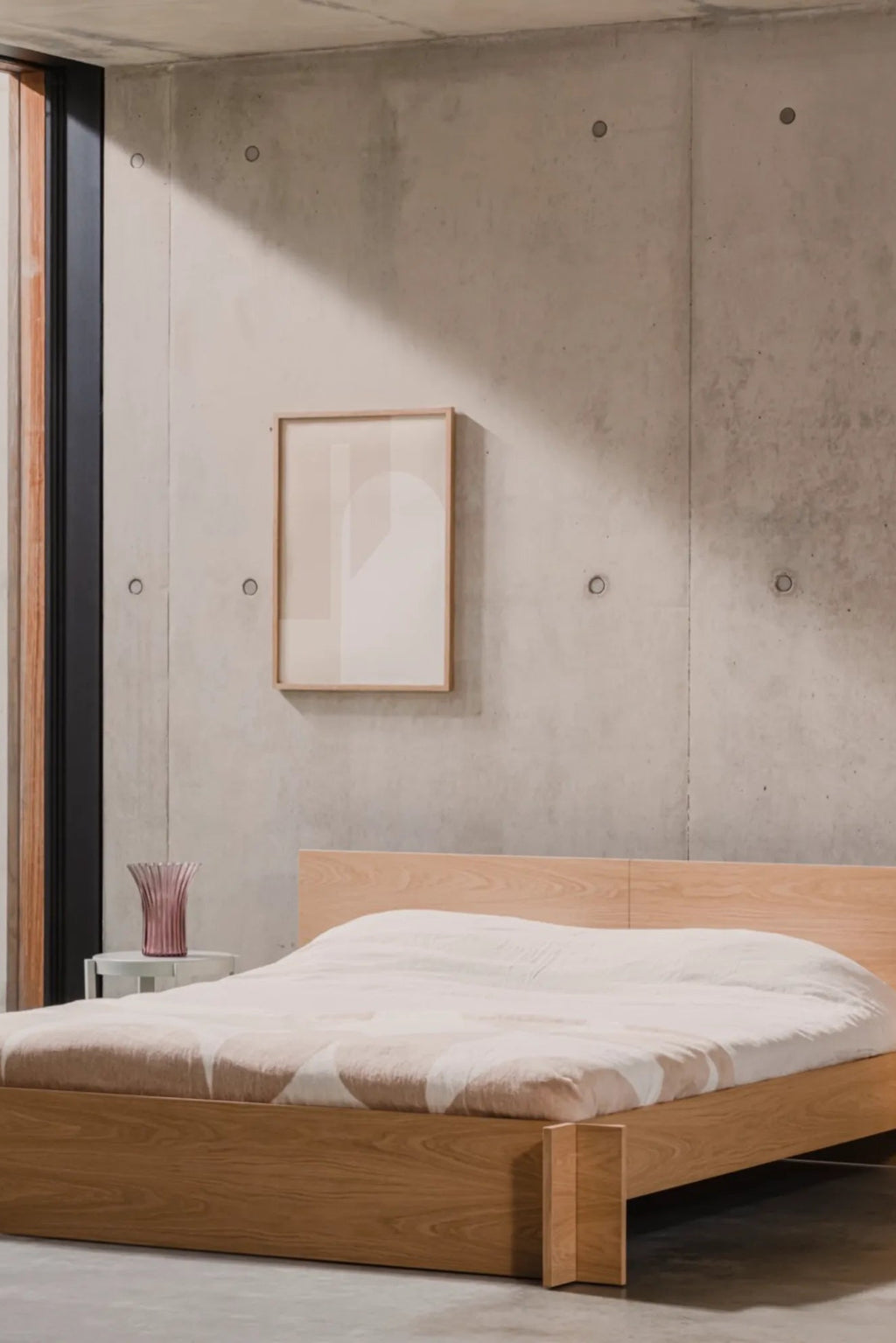 noo.ma Valt Bed, a modern minimalist platform bed crafted from light natural solid oak wood, featuring a low-profile design with clean lines and an integrated headboard. This Scandinavian-inspired bed is perfect for creating a serene contemporary bedroom or an organic modern sleep space.