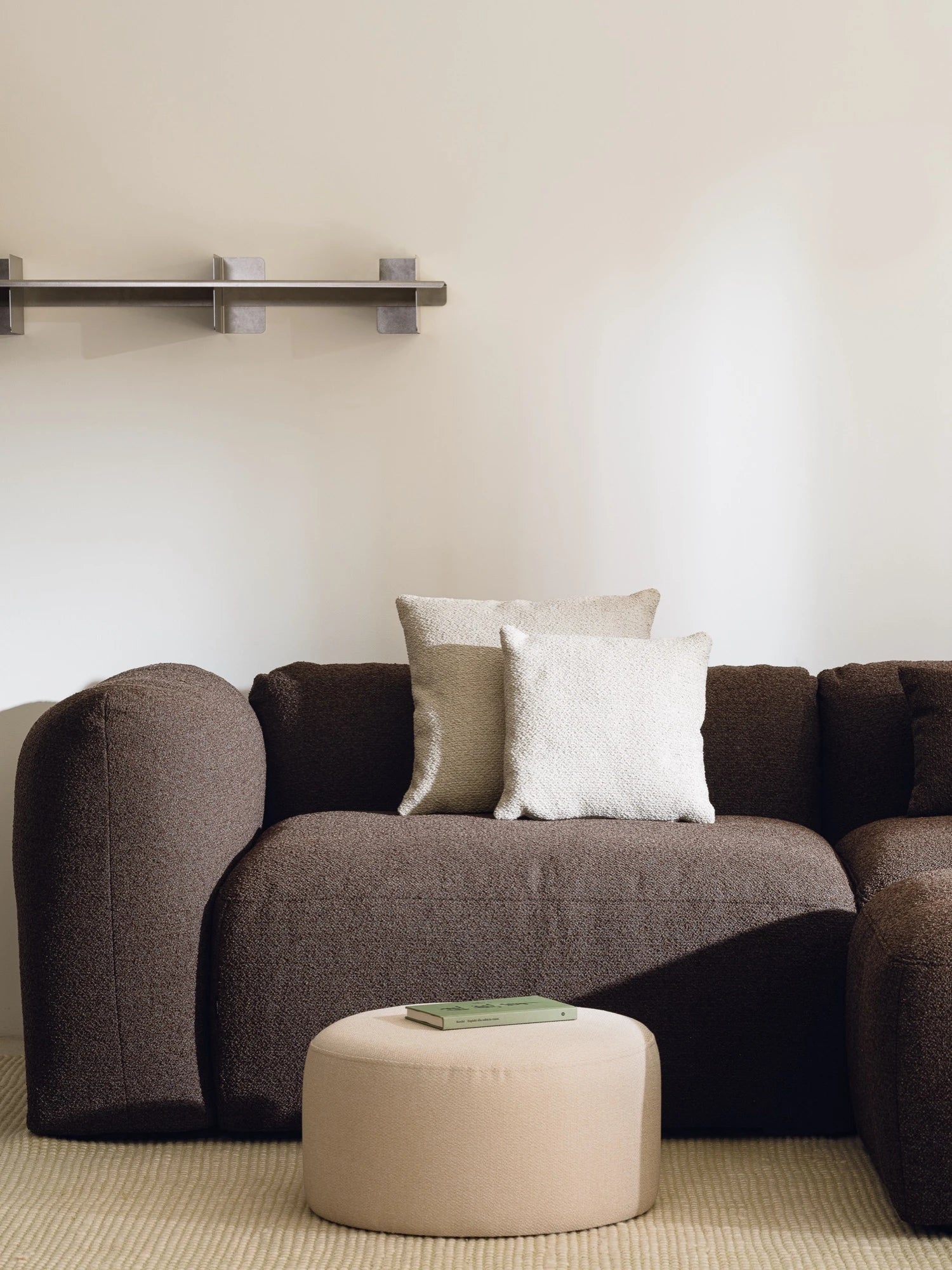 noo.ma Yaro Sofa, a deep dark brown bouclé fabric sofa with an inviting organic modern design, featuring plush rounded arms and a soft, textured finish. This contemporary bouclé couch offers comfortable seating for minimalist or Japandi living room interiors.