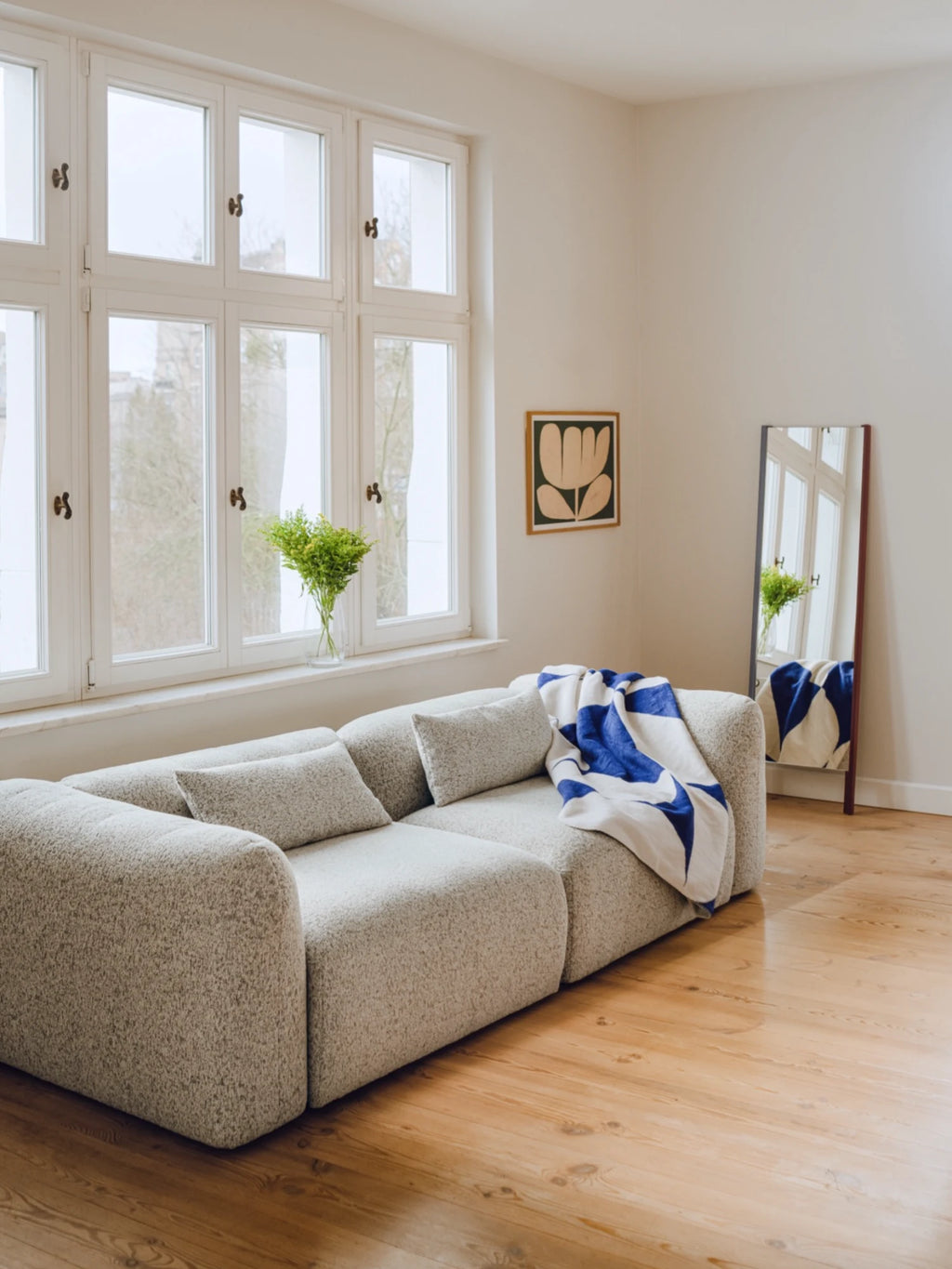 noo.ma Yaro Sofa, a contemporary modular sofa upholstered in a light grey speckled bouclé fabric with a soft, textured finish, featuring a low-profile design, deep seating, and gently rounded edges. This organic modern sofa is perfect for minimalist living rooms, Scandinavian interiors, or cozy small apartment spaces.