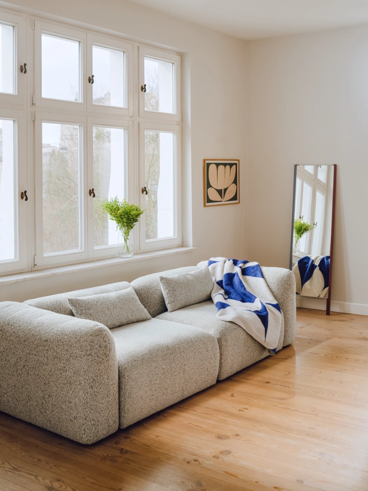noo.ma Yaro Sofa, a contemporary modular sofa upholstered in a light grey speckled bouclé fabric with a soft, textured finish, featuring a low-profile design, deep seating, and gently rounded edges. This organic modern sofa is perfect for minimalist living rooms, Scandinavian interiors, or cozy small apartment spaces.