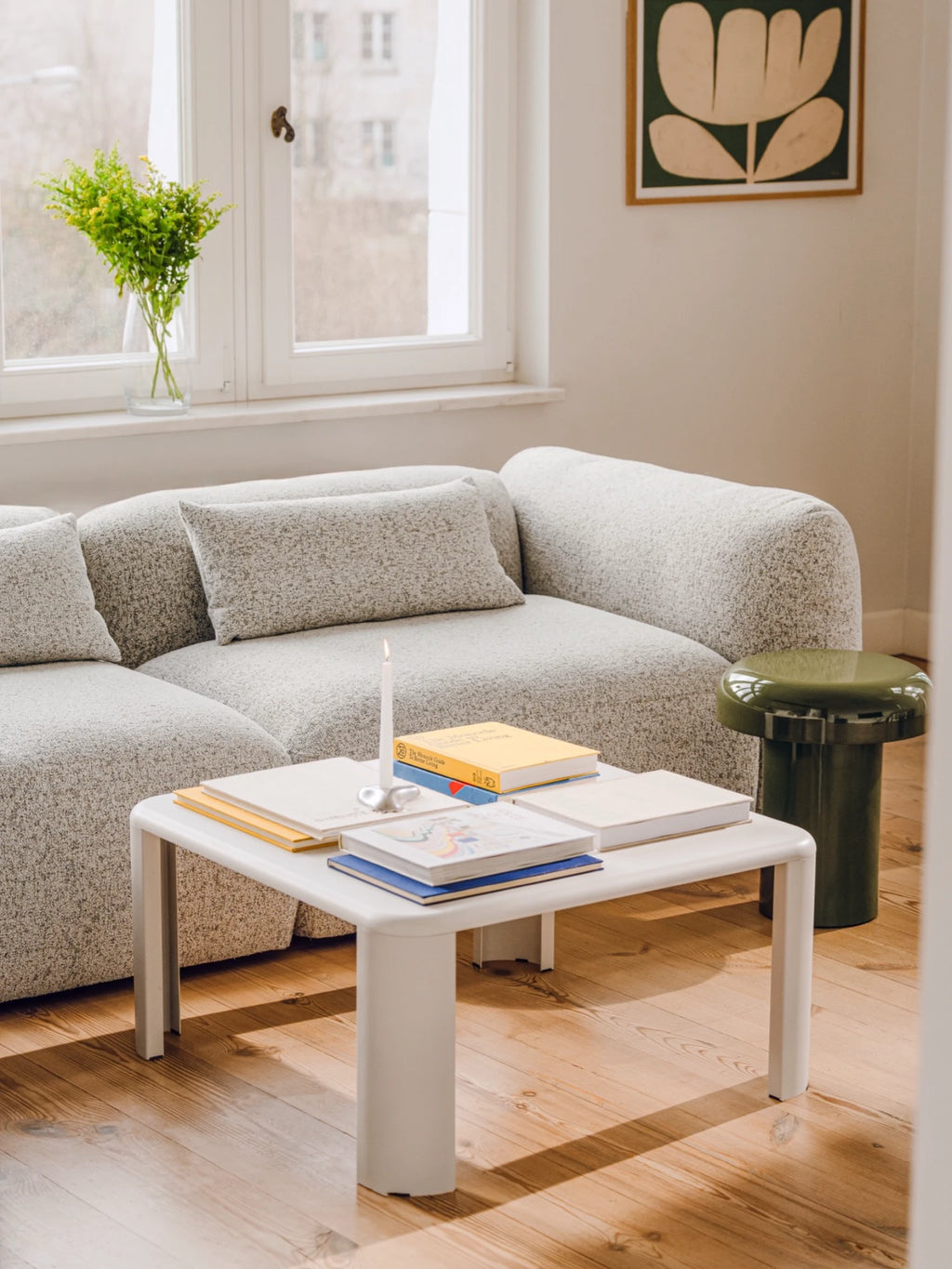 noo.ma Yaro Sofa, a contemporary organic modern sofa upholstered in a soft, textured light grey bouclé fabric, featuring a gently curved, low-profile design with deep, plush seating. This inviting modular couch offers minimalist sophistication, ideal for a cozy living room, Scandinavian lounge, or modern apartment space.
