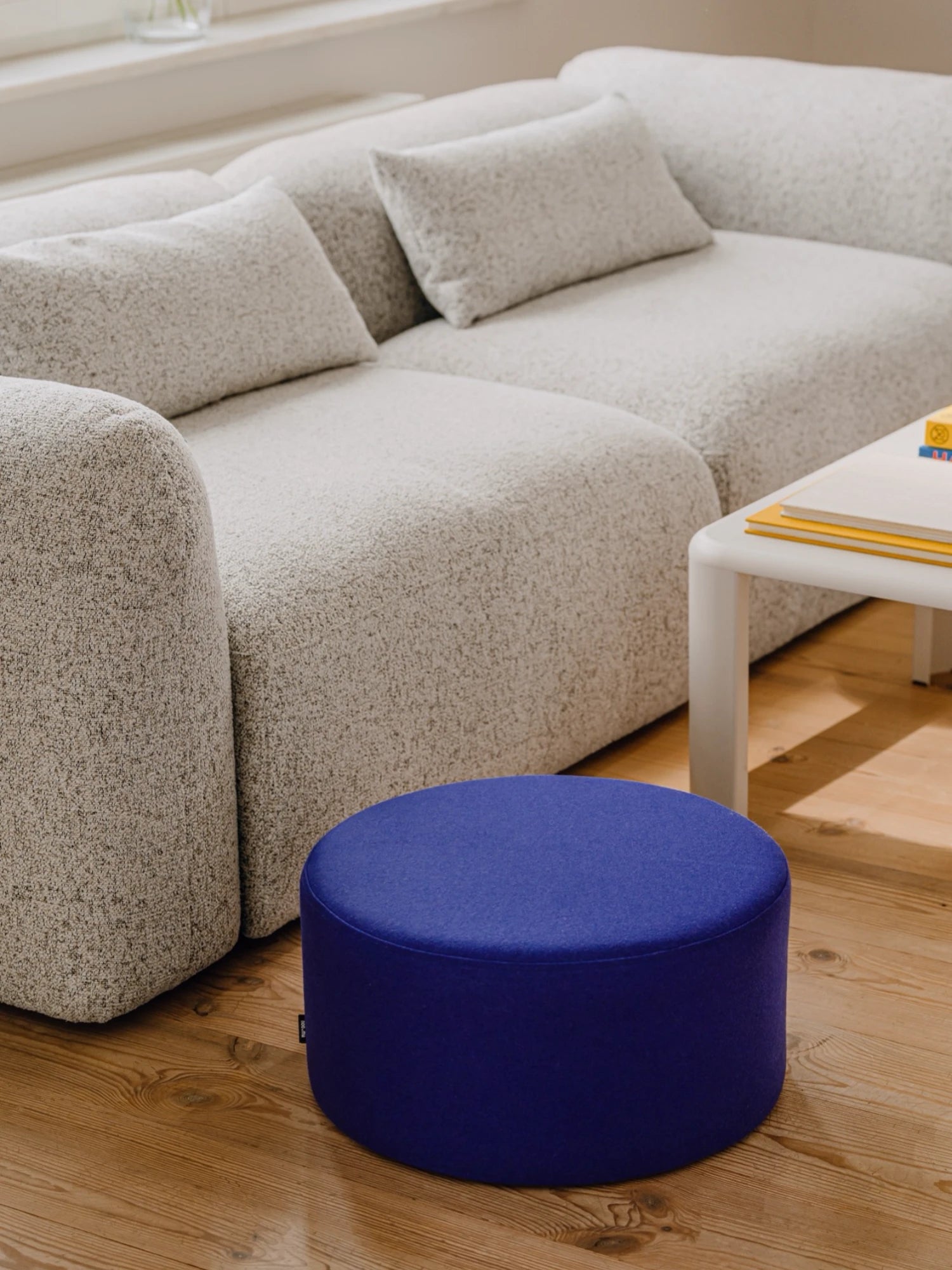 noo.ma Yaro Sofa, a contemporary modular sofa upholstered in a light grey textured bouclé fabric, featuring a low profile, deep seating, and gently rounded edges for an organic modern aesthetic. This versatile sectional sofa is perfect for creating a cozy yet stylish living room in minimalist or Scandinavian-inspired homes.