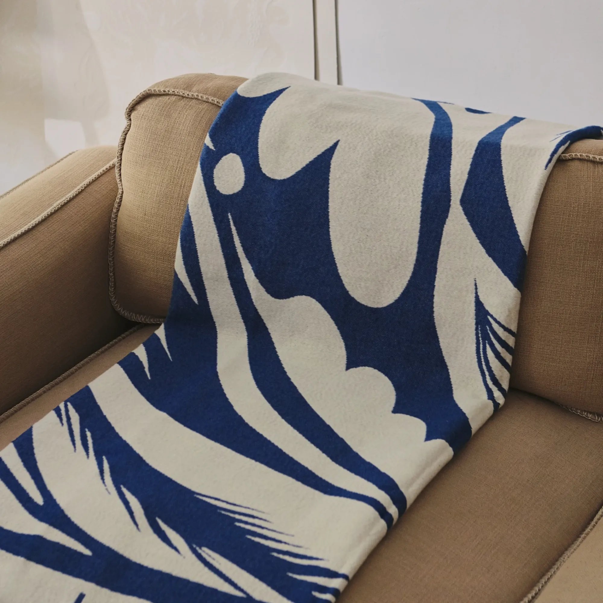  Lino Throw Blanket being used as a decorative accent in a nursery