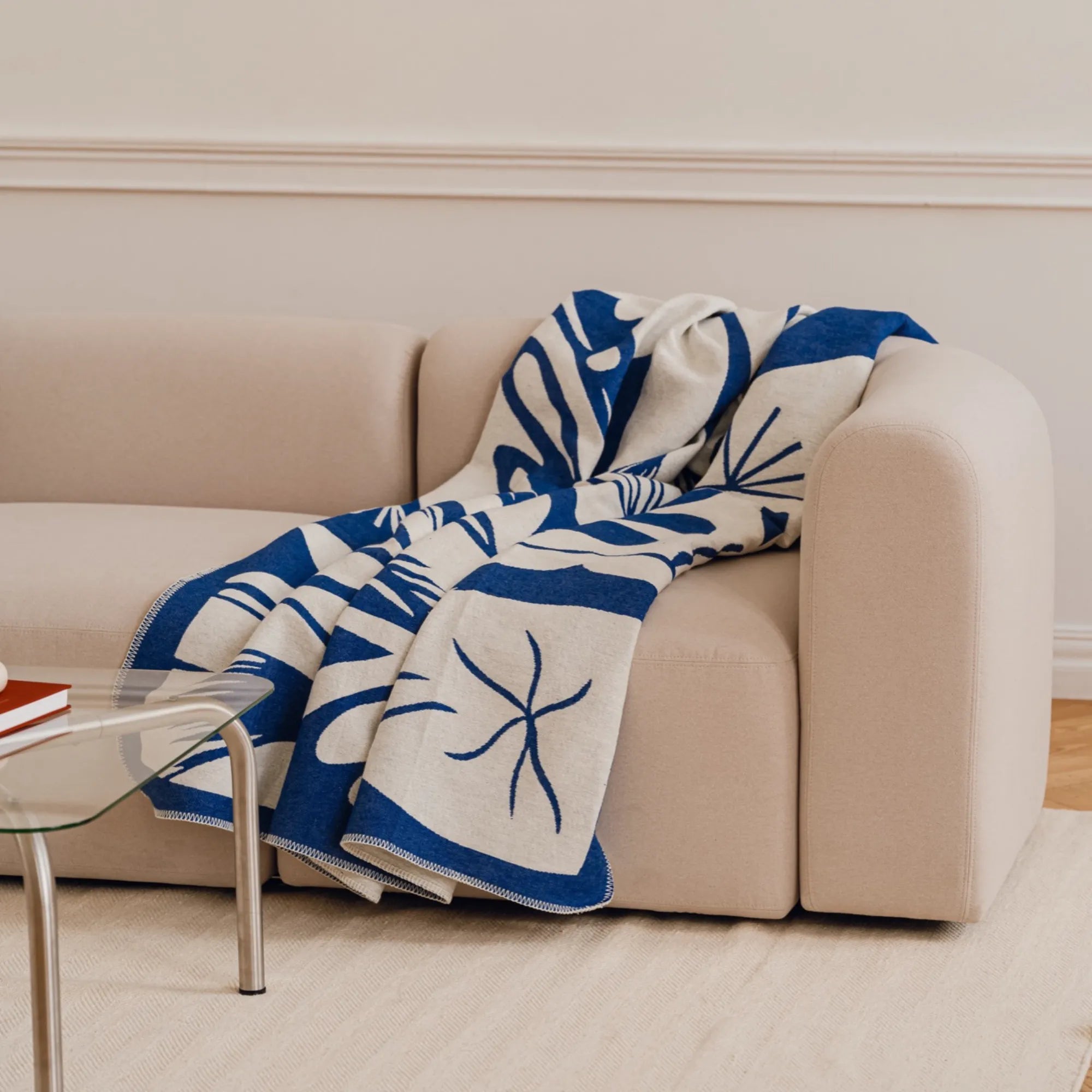 Soft and cozy Lino Throw Blanket in neutral color, perfect for snuggling on the couch or adding a touch of warmth to your home decor