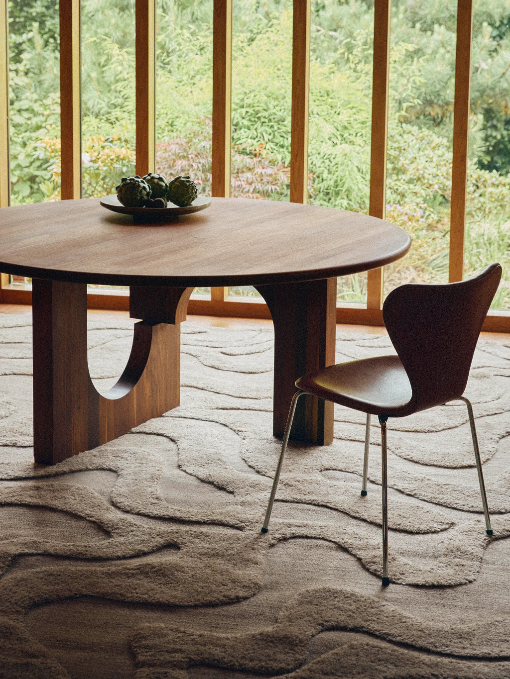 Tinted Objects Norlander Wool Rug, a premium hand-tufted wool area rug in natural beige and oatmeal tones, featuring a distinctive high-low pile that creates an organic, wavy, abstract pattern. Its plush, textured surface adds warmth and depth to any space. Ideal for organic modern living rooms, Japandi dining spaces, or cozy minimalist bedrooms.