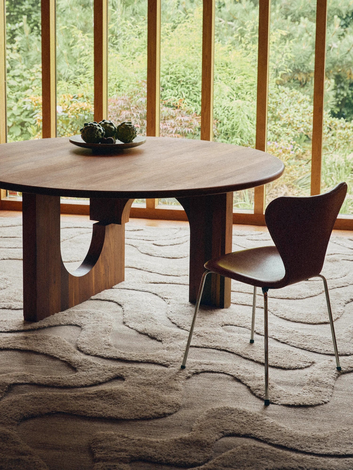 Tinted Objects Norlander Wool Rug, a premium hand-tufted wool area rug in natural beige and oatmeal tones, featuring a distinctive high-low pile that creates an organic, wavy, abstract pattern. Its plush, textured surface adds warmth and depth to any space. Ideal for organic modern living rooms, Japandi dining spaces, or cozy minimalist bedrooms.