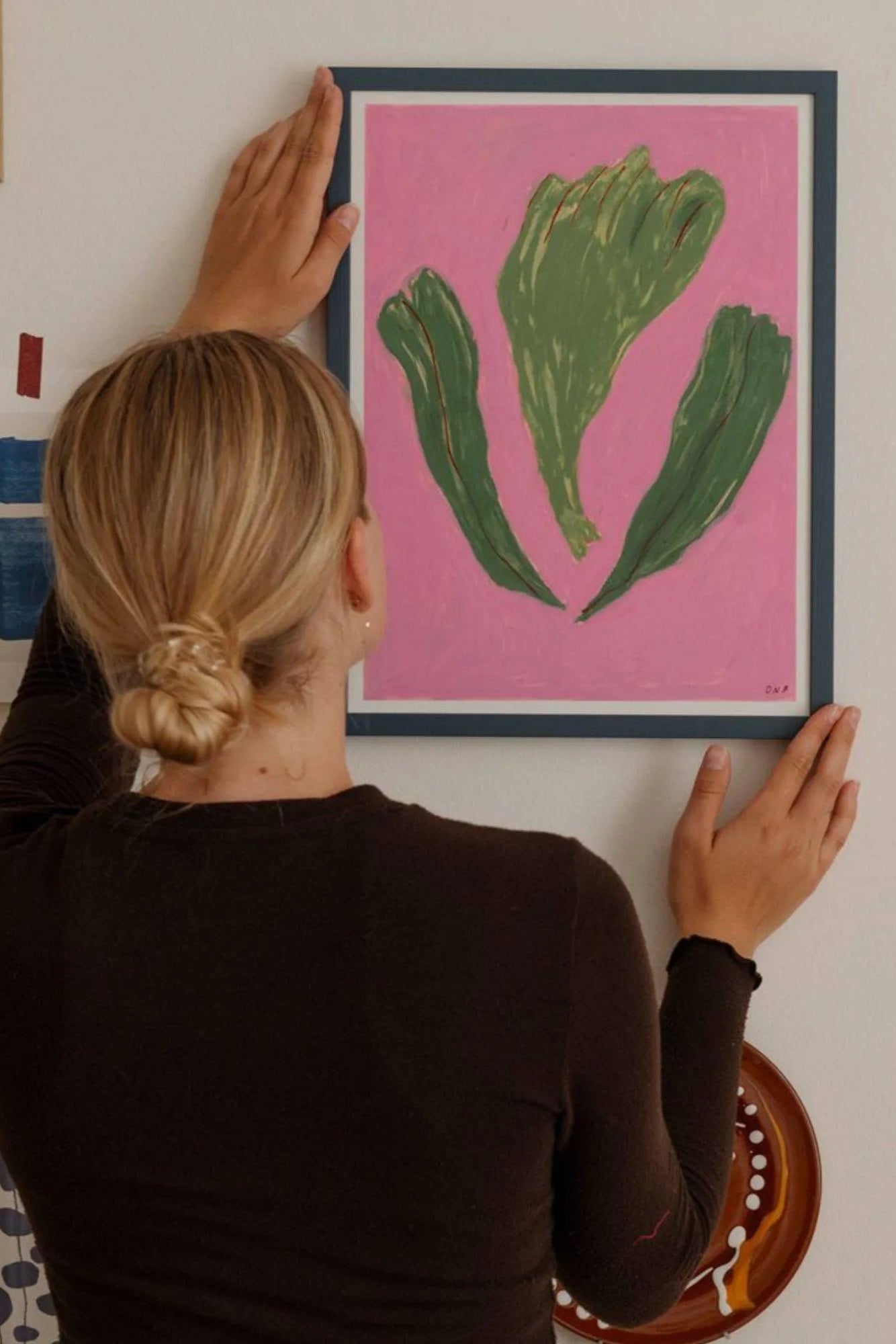 A close-up of a little girl picking ripe blackberries from a thorny bush