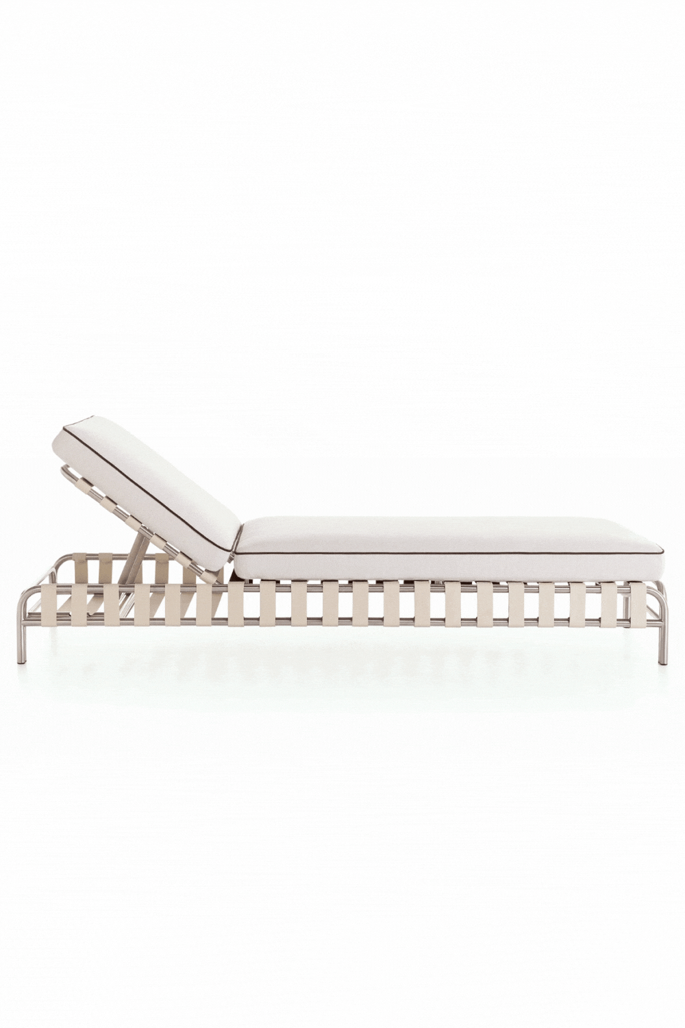 Gandia Blasco Onsen Chaise Lounge, a modern outdoor sunbed crafted with a sleek brushed stainless steel frame and a base of light beige woven straps, topped with a plush white cushion featuring elegant dark brown piping. This contemporary chaise lounge boasts an adjustable backrest for ultimate comfort, ideal for luxury poolside lounging or minimalist patio designs.