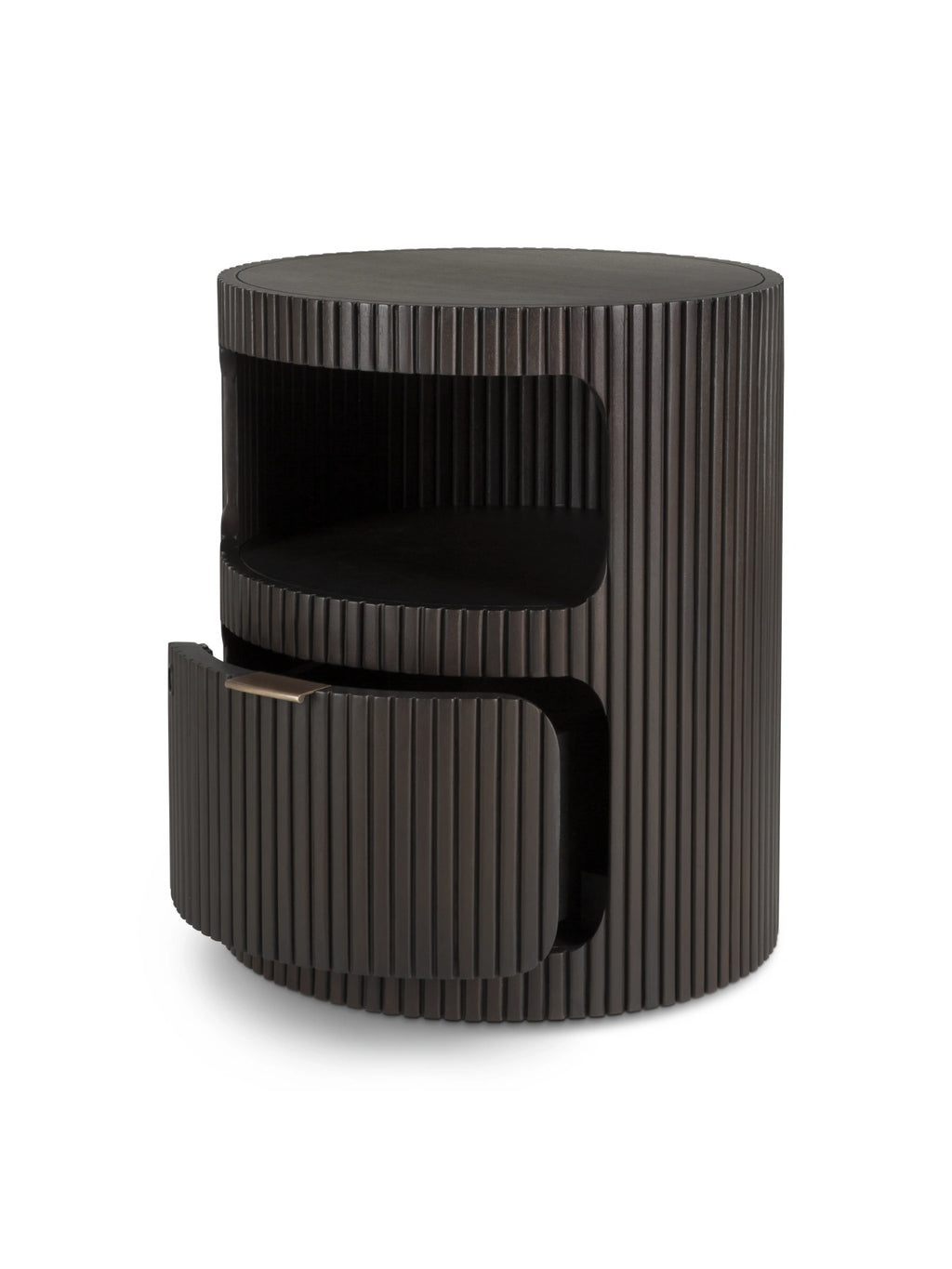 Ethnicraft Boomerang Drawer Unit, a striking round side table crafted from dark solid wood, featuring a distinctive fluted or ribbed texture around its entire cylindrical form. This modern minimalist storage unit includes an open shelf compartment and a curved drawer with a subtle brushed bronze pull handle, offering both display and concealed storage. Ideal as a sculptural bedside table in a contemporary bedroom or a functional accent piece in an organic modern living room.