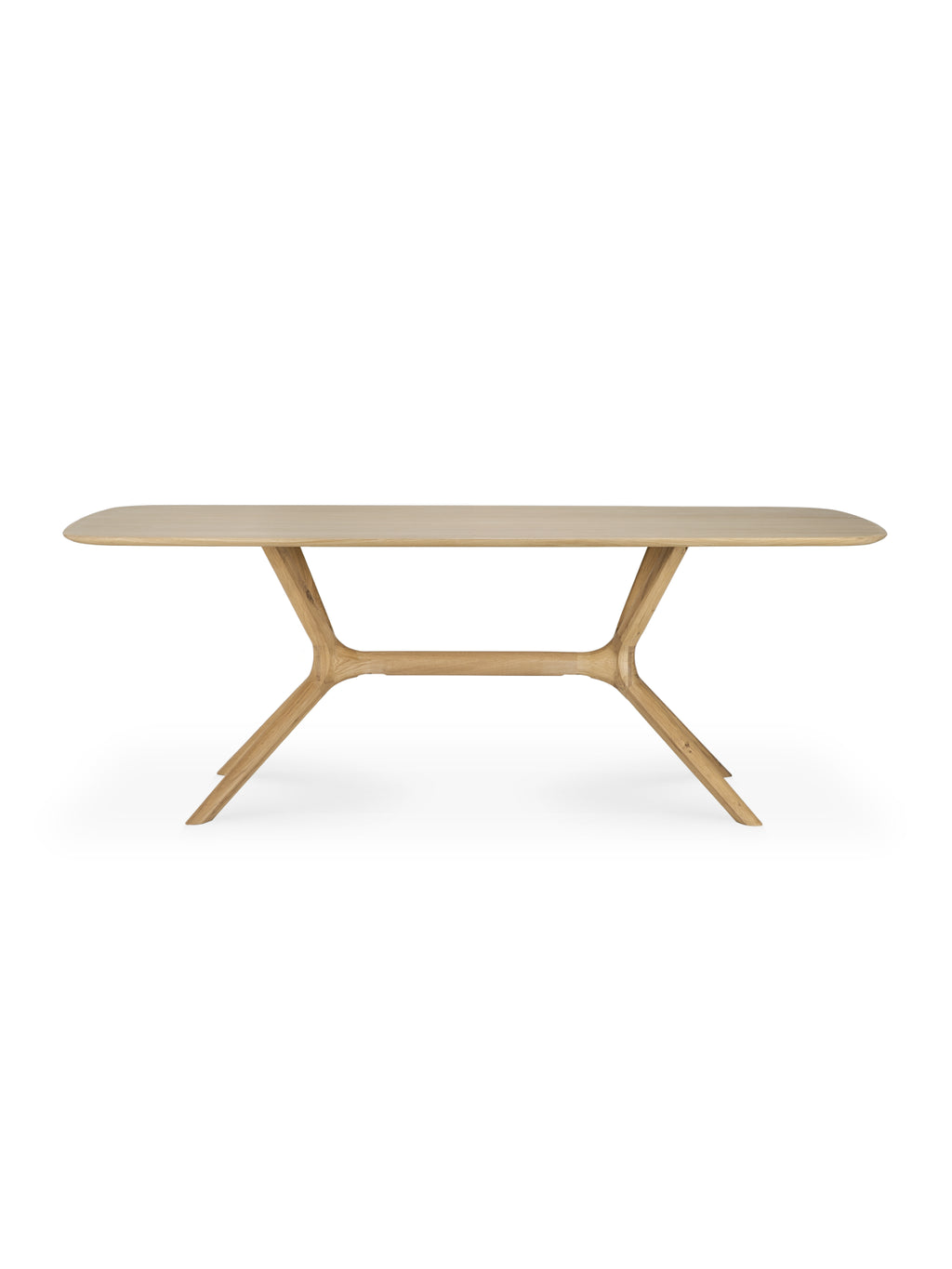 Ethnicraft X Dining Table, a rectangular dining table crafted from light oak wood, featuring a distinctive X-shaped base with angled legs, highlighting its sturdy construction and modern, sculptural design, displayed on a white background.
