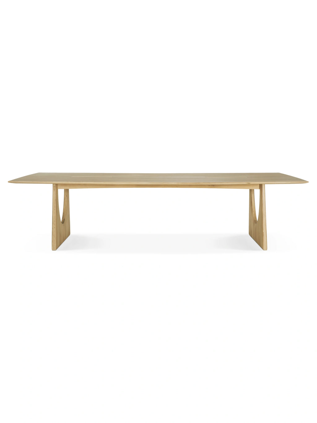 Ethnicraft Geometric Meeting Table, a modern minimalist dining table crafted from light natural solid oak with a smooth finish and a rectangular top featuring subtly tapered edges. Its distinctive geometric V-shaped legs, each with a unique cutout, create a sculptural and contemporary aesthetic. Ideal as a stylish dining room table, conference table, or home office desk for design-conscious interiors.