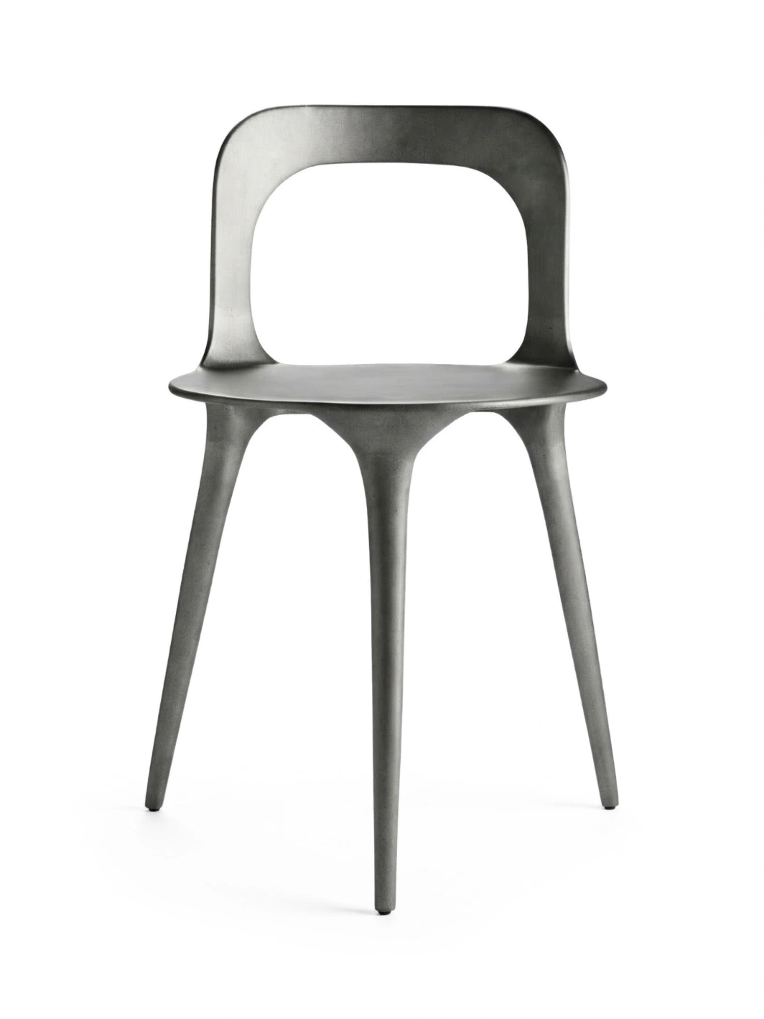 Tine K Dune Recycled Aluminium Chair, a dark grey organic modern dining chair crafted from matte recycled aluminium with a slightly textured finish and a fluid, sculptural silhouette. It features a curved backrest with a distinctive cutout and slender tapered legs that flow seamlessly from the seat. Perfect as a contemporary dining chair or stylish accent piece for industrial chic or modern minimalist interiors.