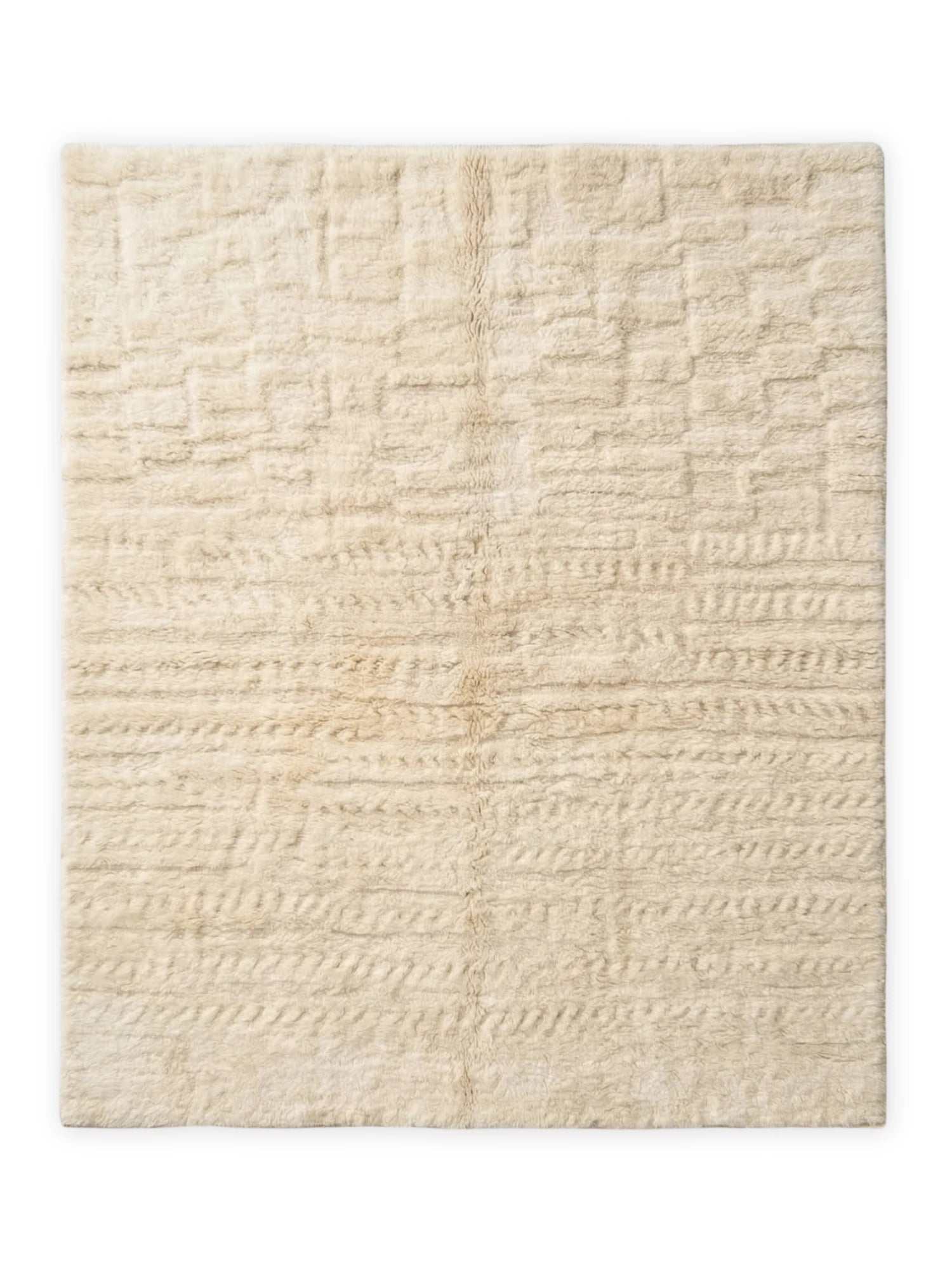 TCL Studios Nomad Wool Rug, a luxurious hand-knotted wool area rug in natural cream and off-white tones, featuring a plush, shaggy pile with a distinct raised geometric and textured pattern.