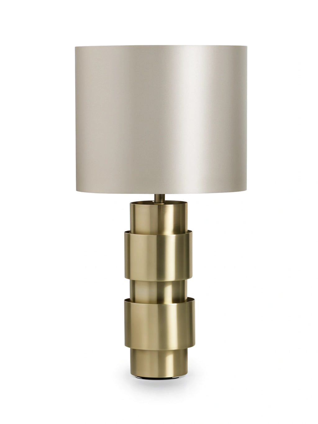 CTO Lighting Ring Table Lamp in a radiant brass finish, showcasing its modern stacked cylindrical base design and a sleek light grey fabric drum shade, on a white background.